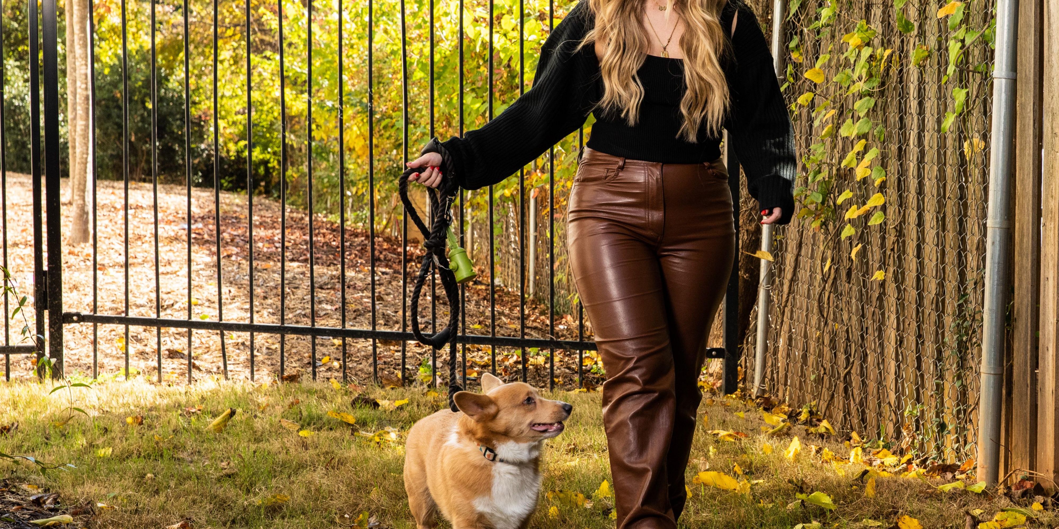 Woman walking dog outside of hotel