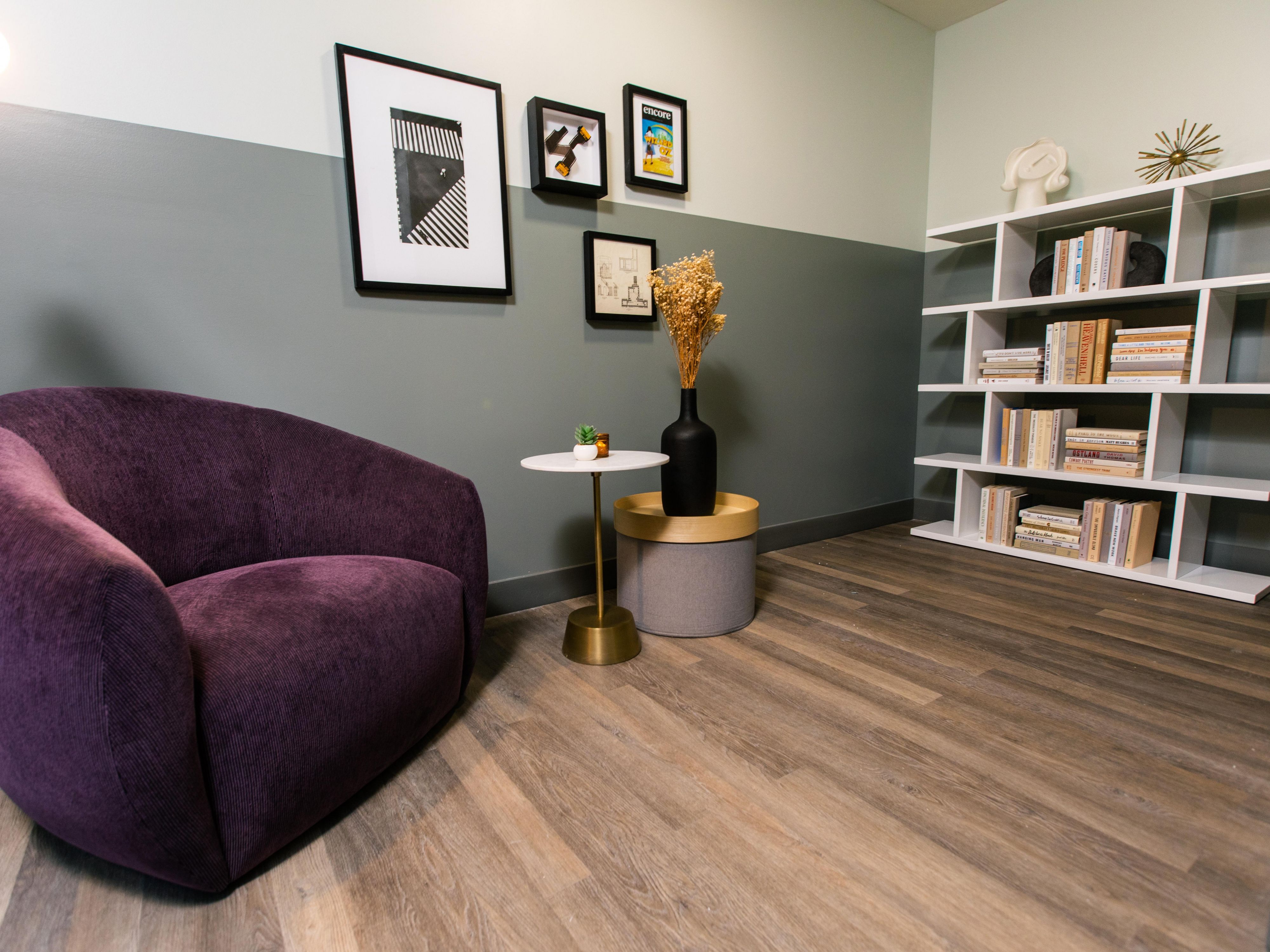 Book case filled with books and a comfy chair