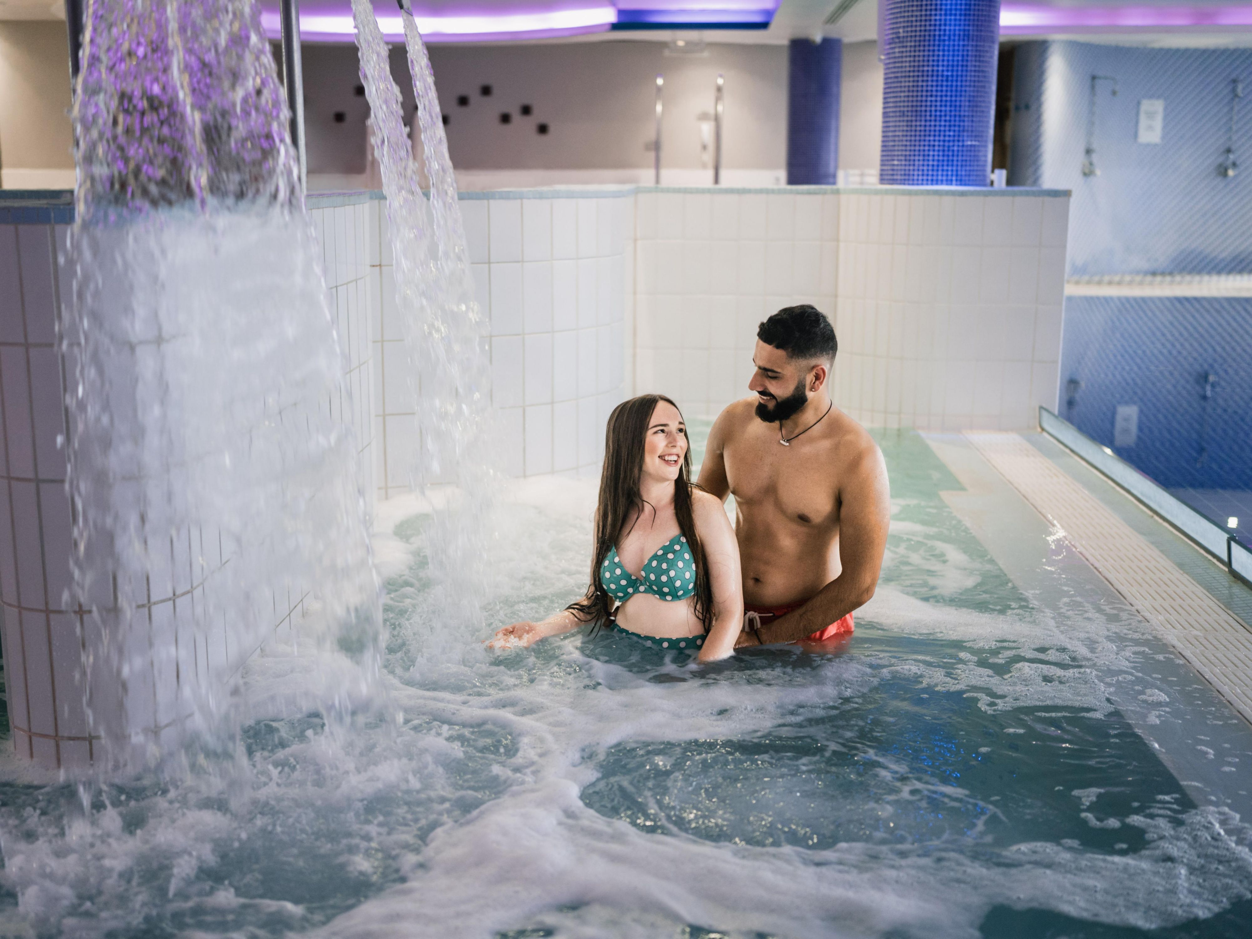 Couple enjoying the pool at the spa