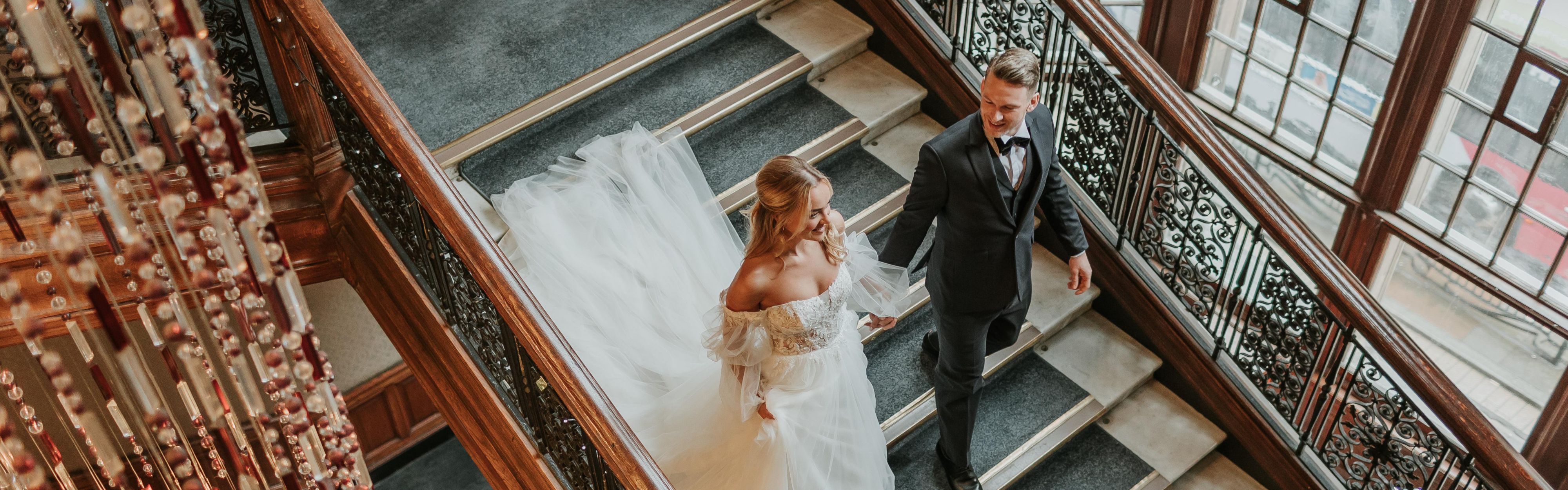 Bride and groom descending the stairs