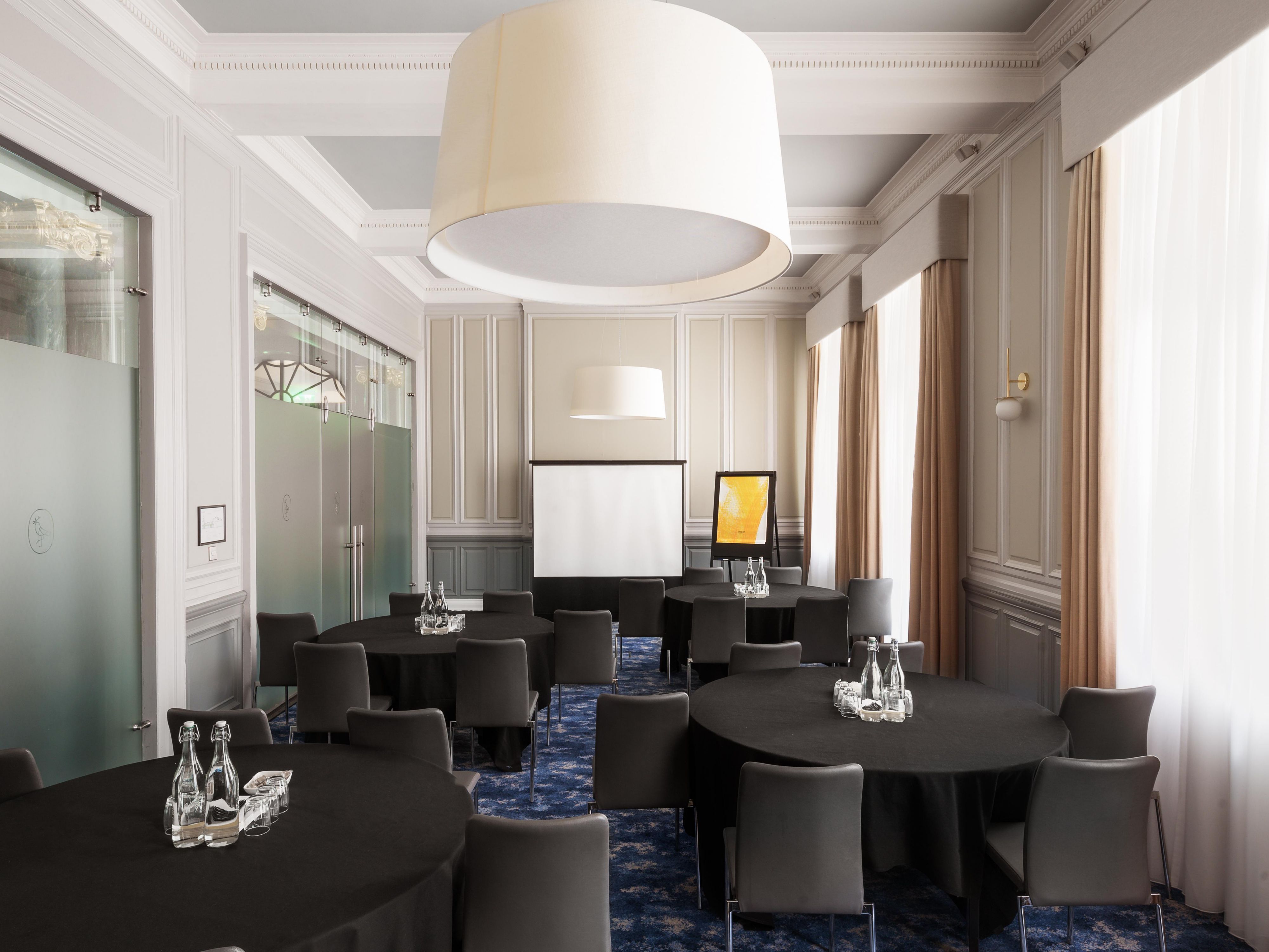 Meeting room with round tables and a presenting area