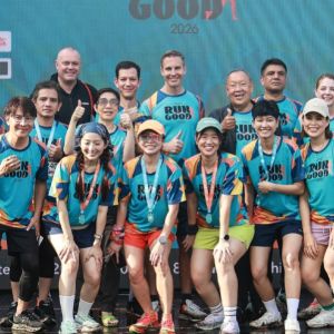 Group of runners posing together at an event.
