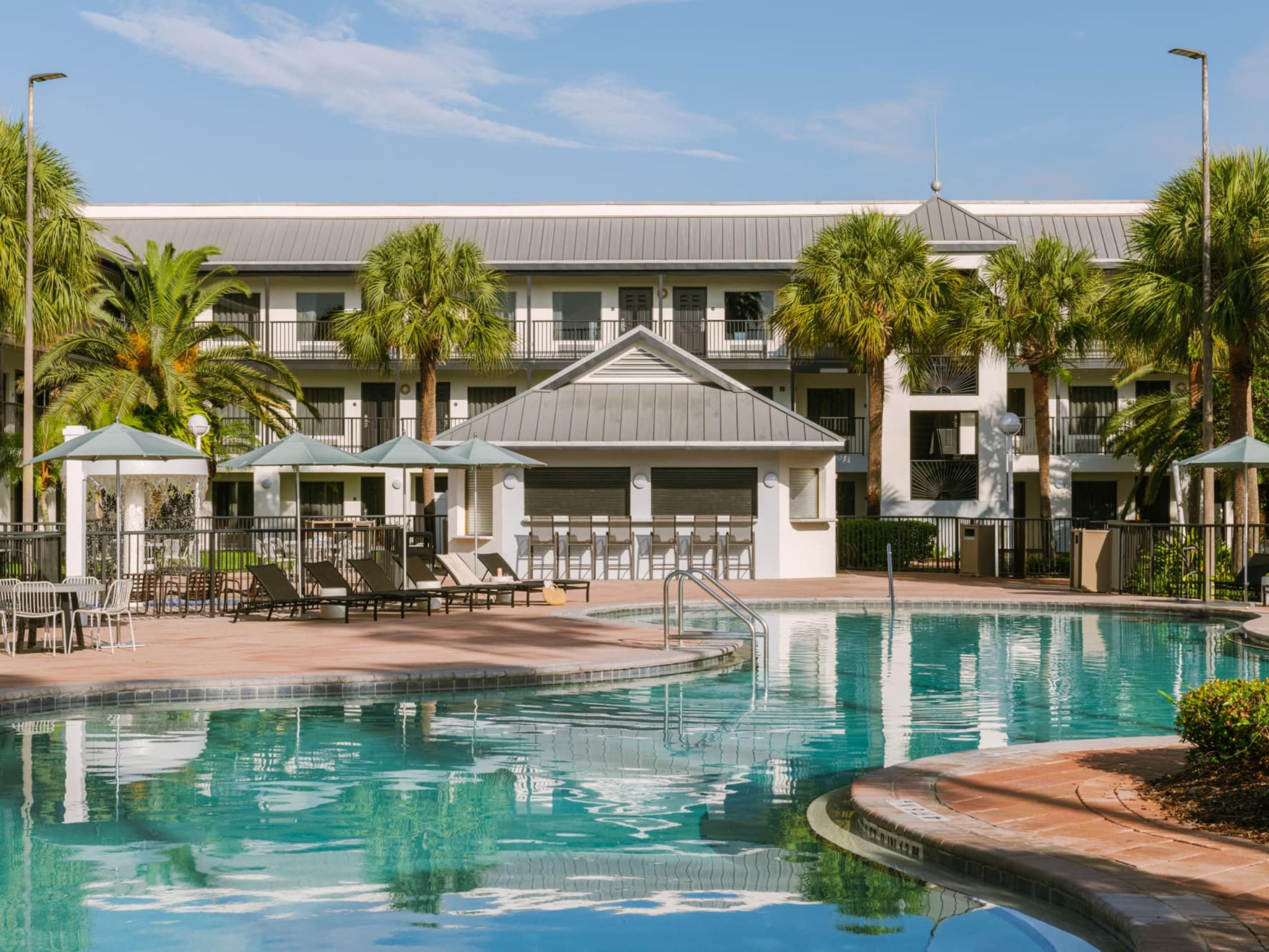 Dive into relaxation at our tropical oasis pool—your perfect escape just steps from your room.