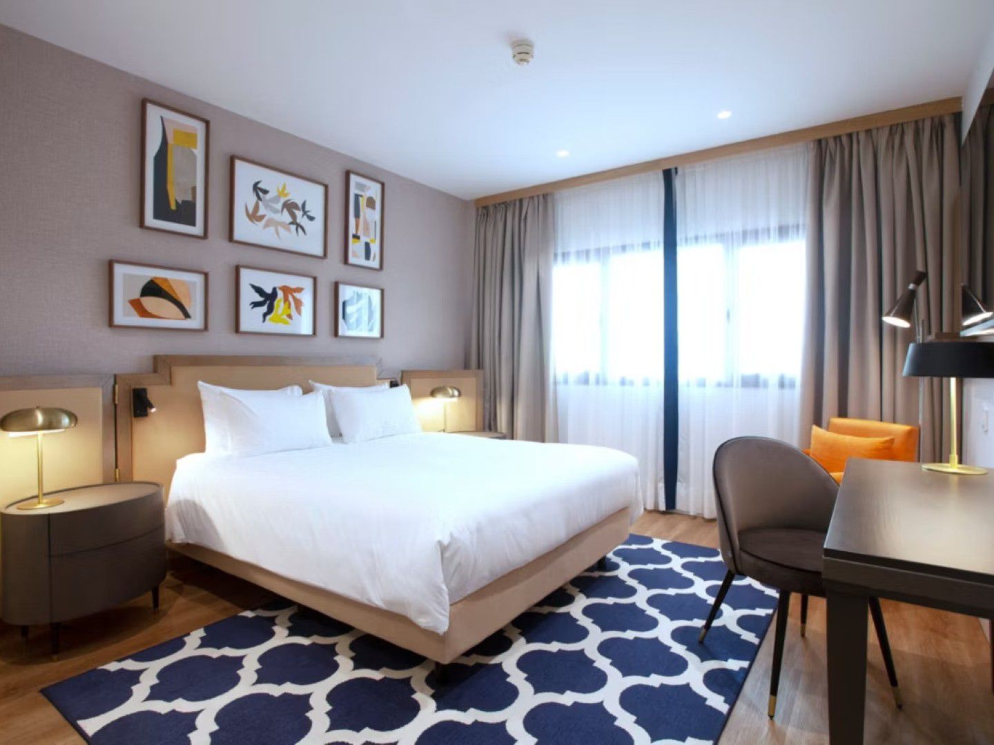 A wide-angle image of one of the bedrooms at voco Madrid - Las Tablas