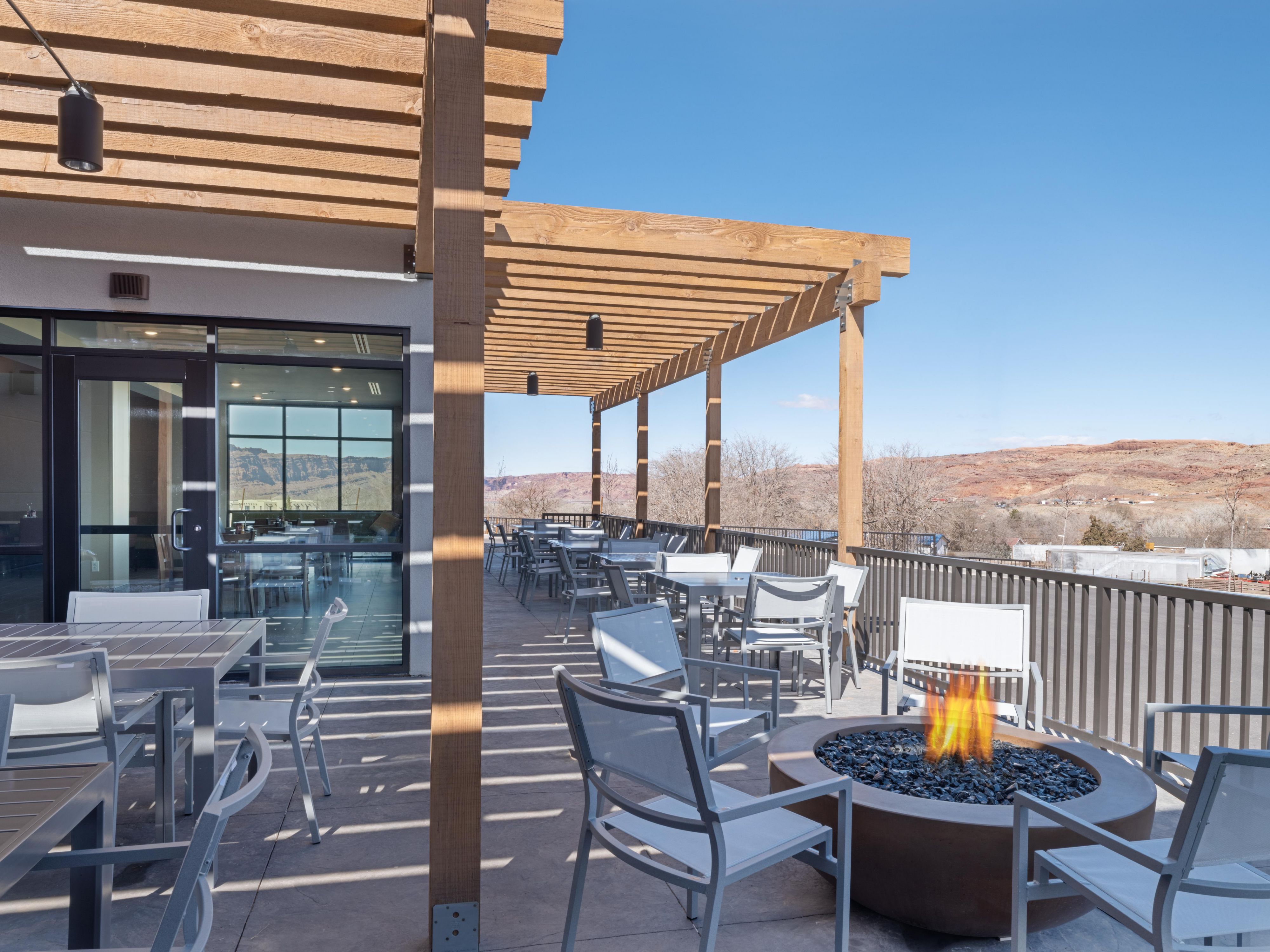 Unwind by the outdoor fireplace on the patio, a relaxing spot to share stories after a day of Moab adventures under the starry desert sky.