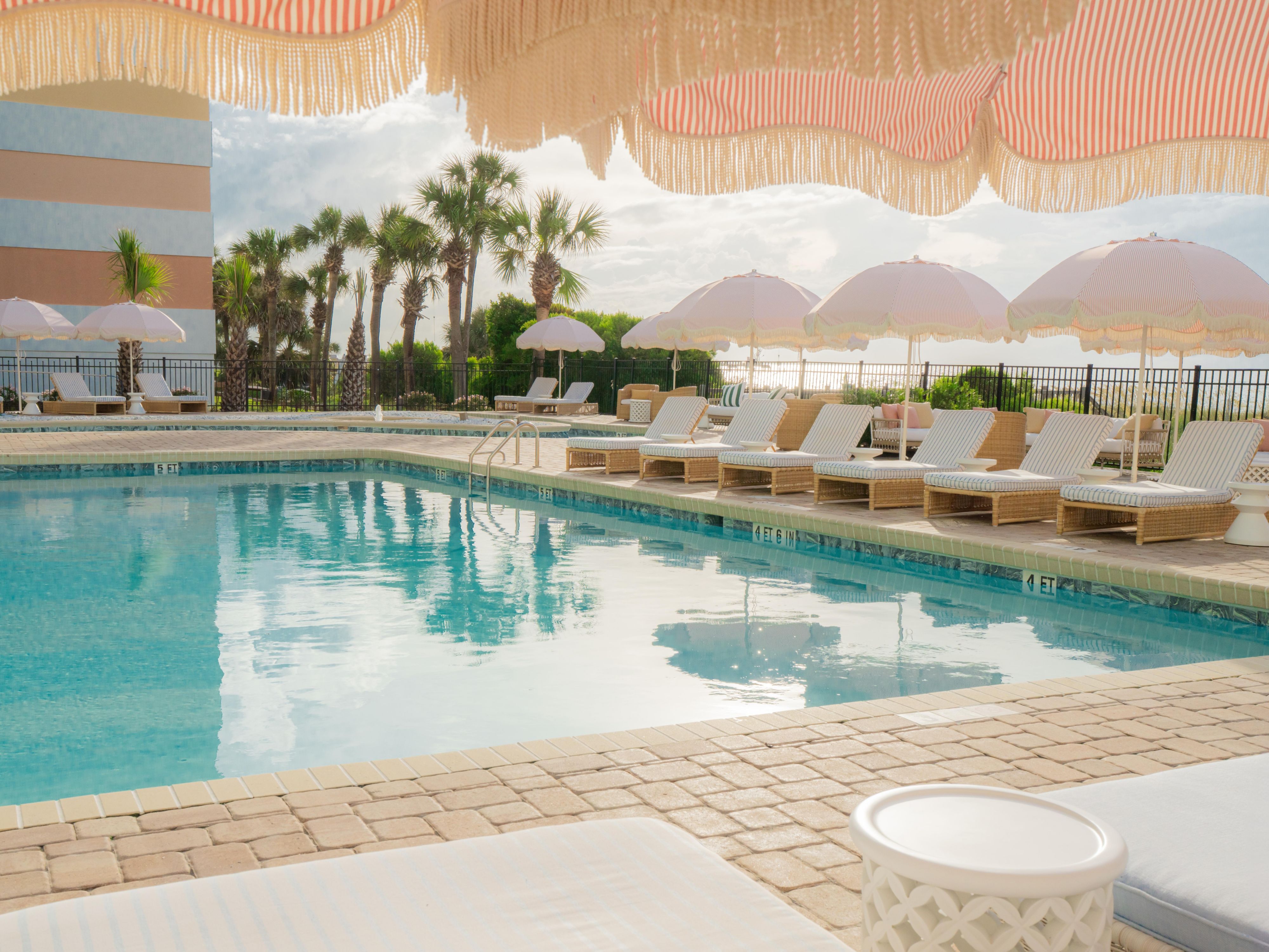 Palm-lined pool at voco The Shelby - Myrtle Beach hotel.