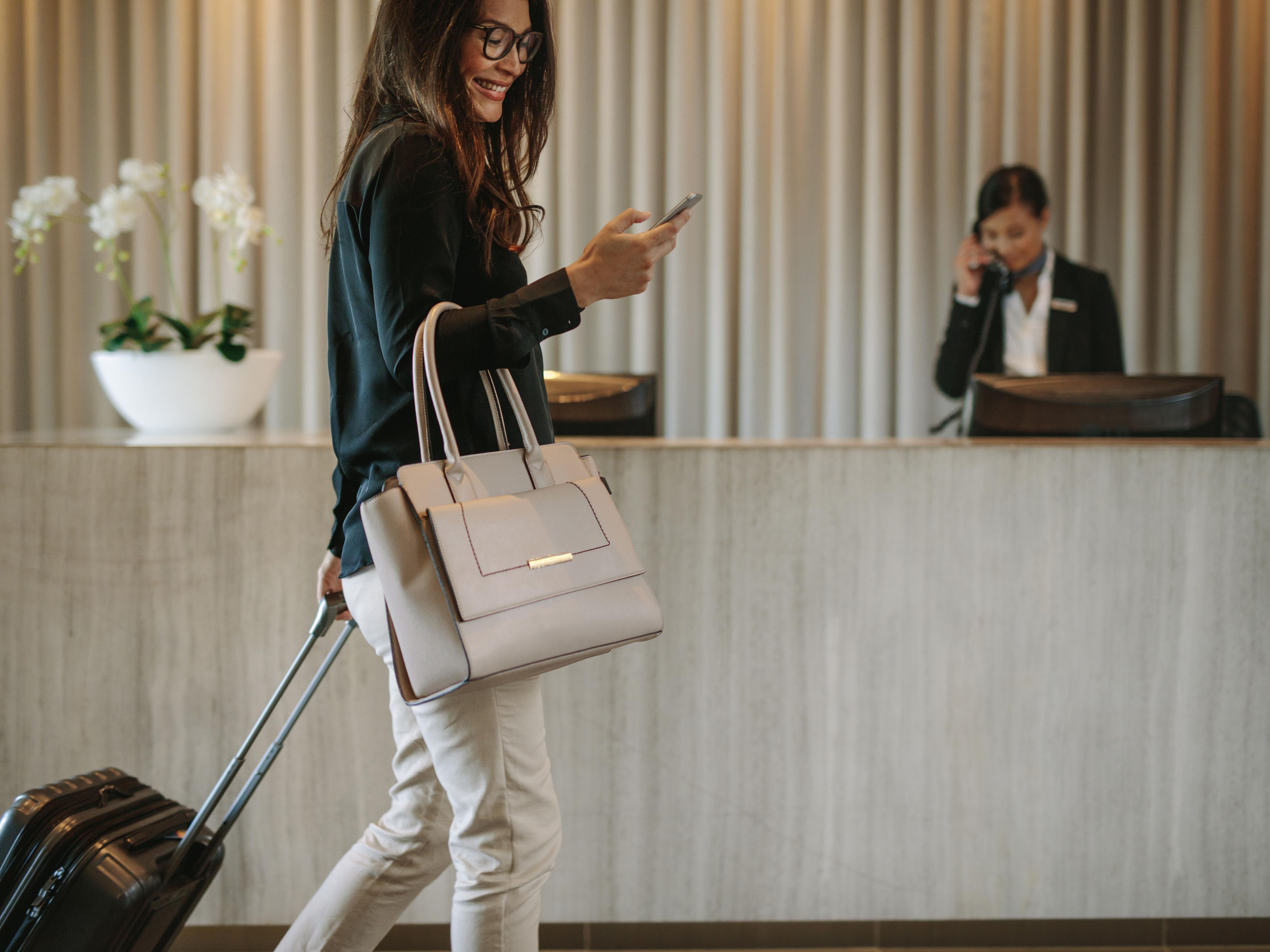 Business woman checking into hotel