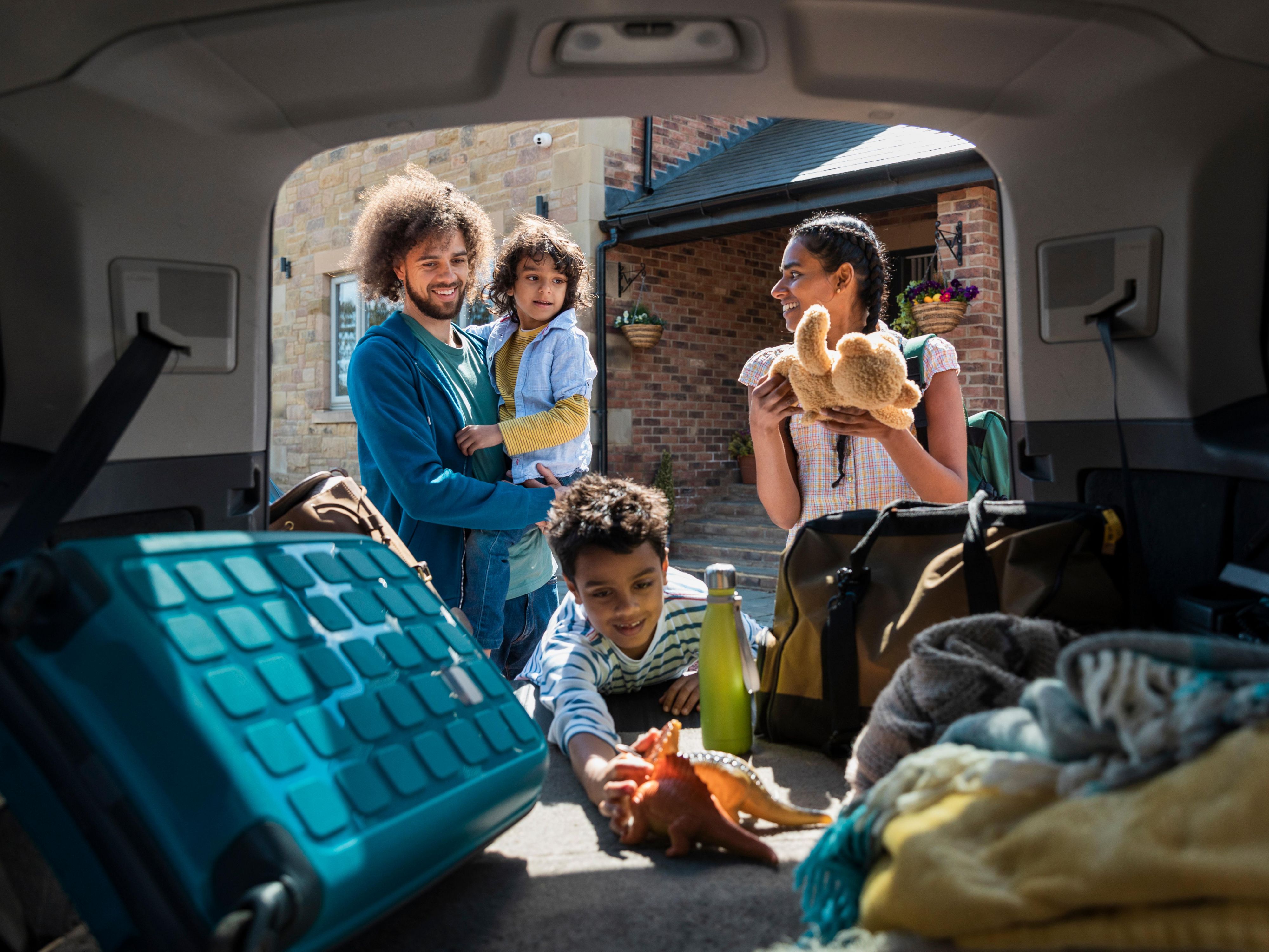 Family packing car for a staycation close to home. 