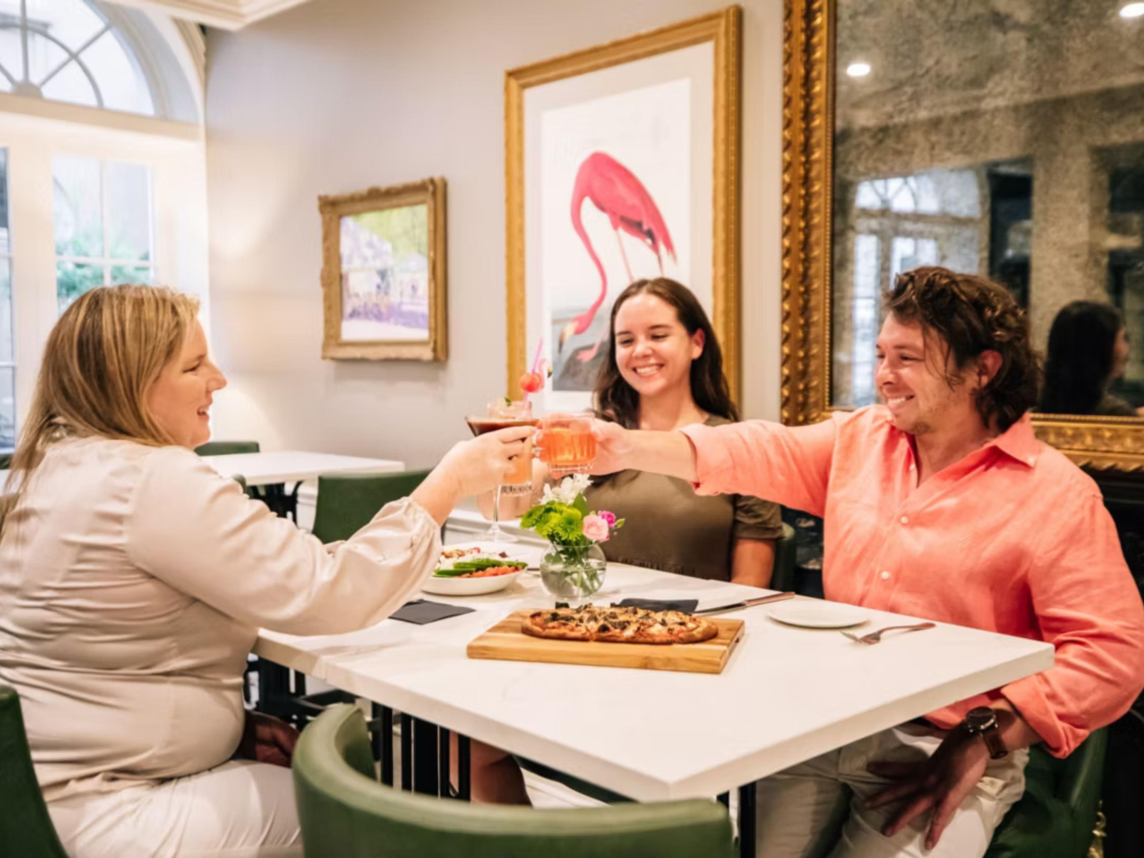 Friends toasting at Café Flamant