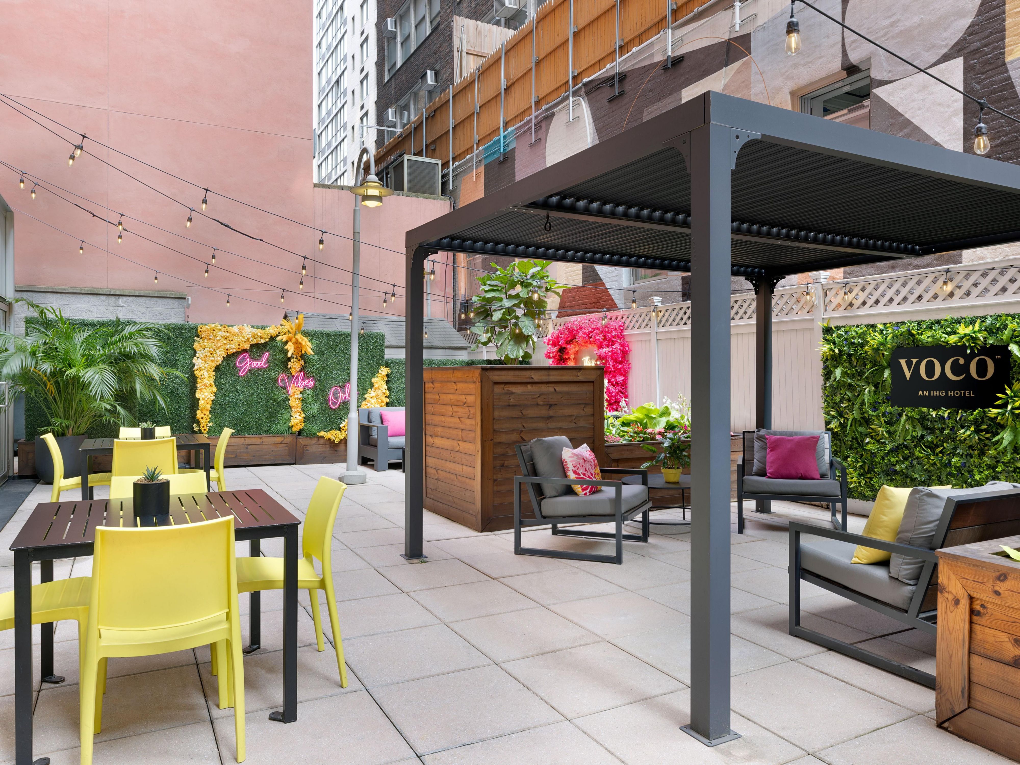 Vibrant mural art meets Manhattan views on our outdoor patio.