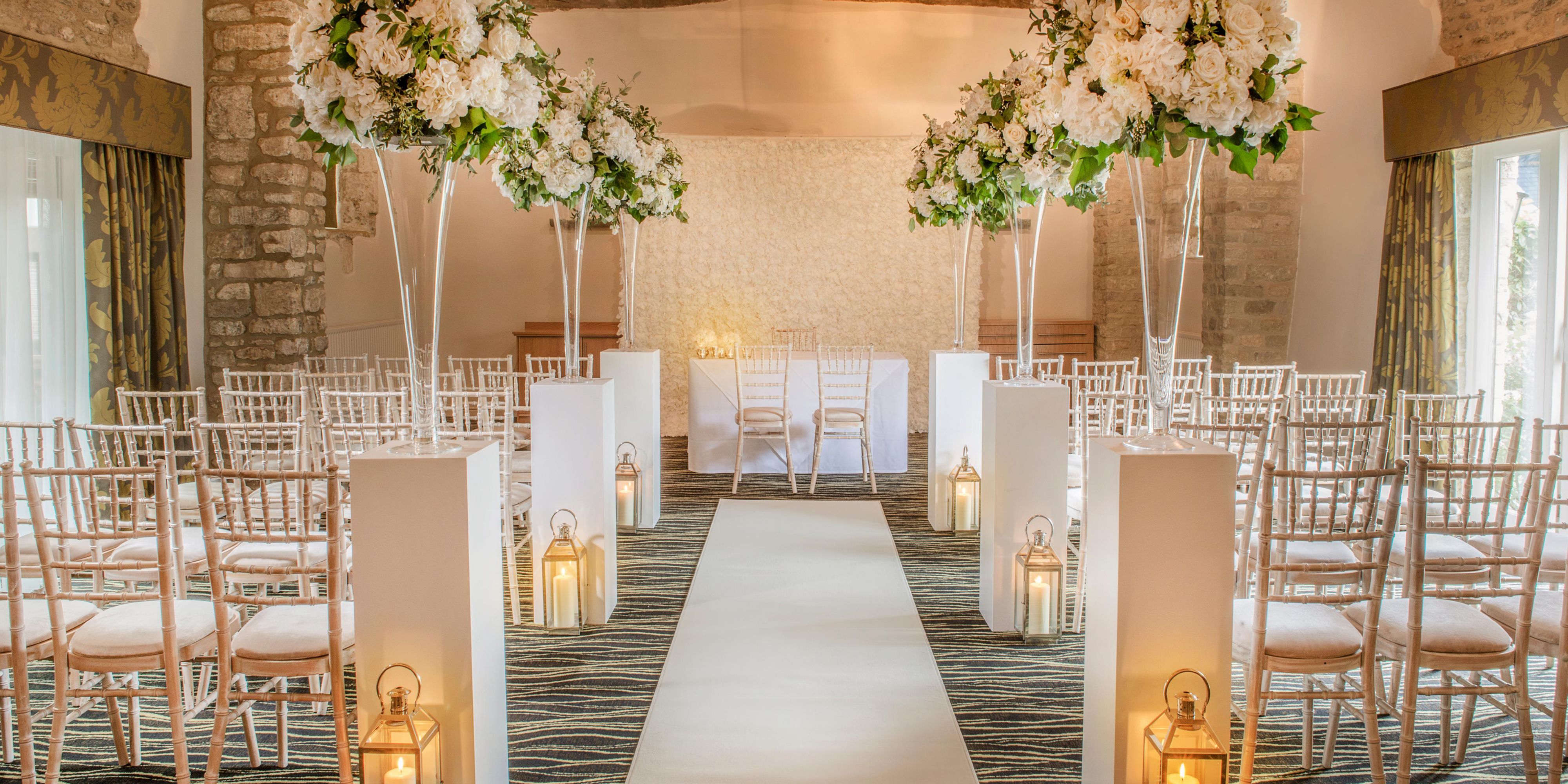 Say 'I do' at voco® Oxford Thames. The tree-lined driveway unveils Cotswold stone buildings, medieval barns, and a Grade II listed 15th-Century manor house. Set on 30 acres by the River Thames, it's the perfect backdrop for your wedding day.