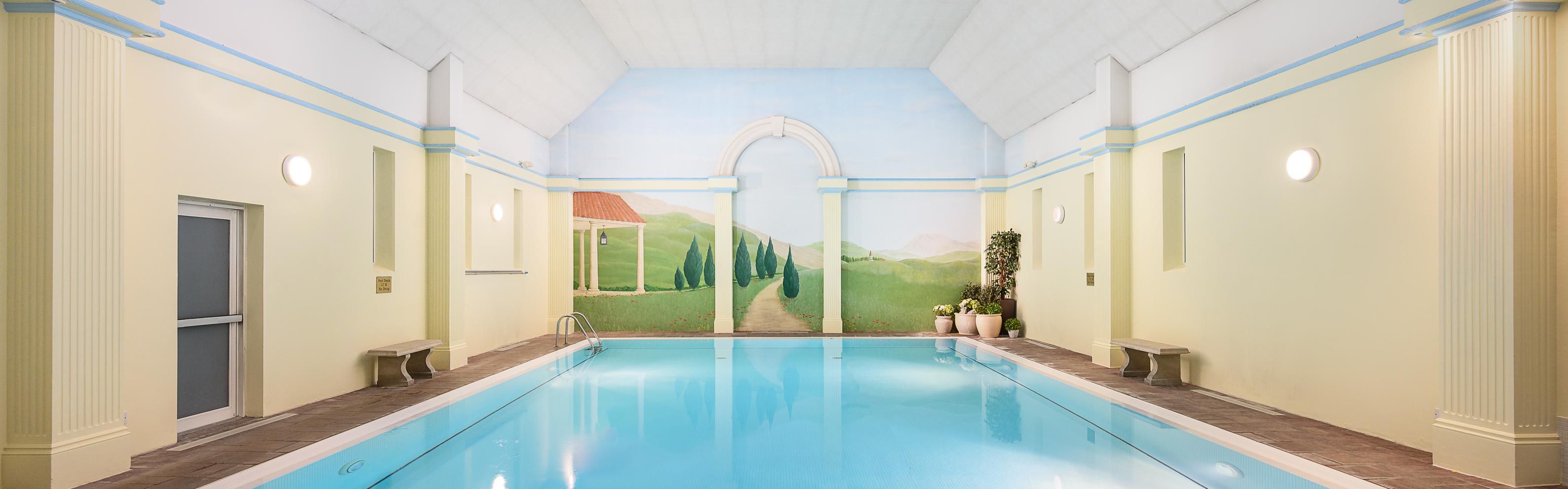 Large pool with rustic wall painting