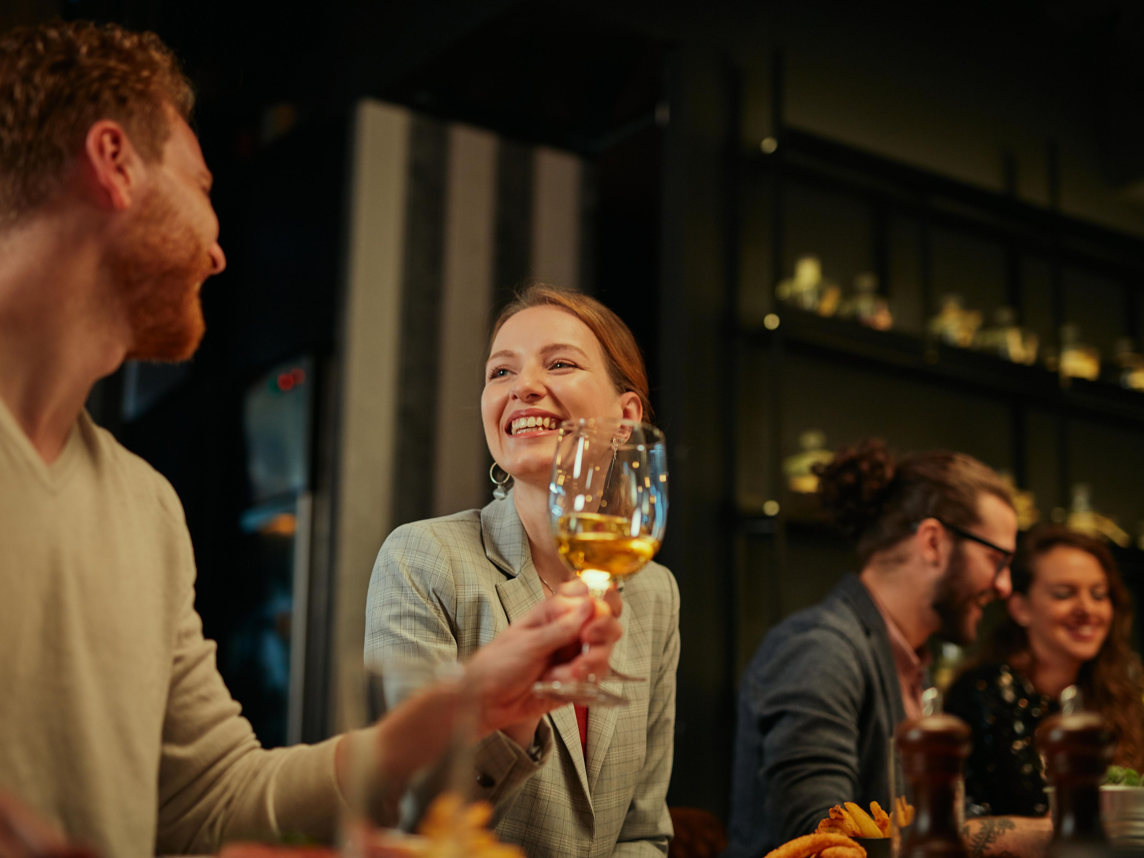 couple cheersing their drinks and smiling