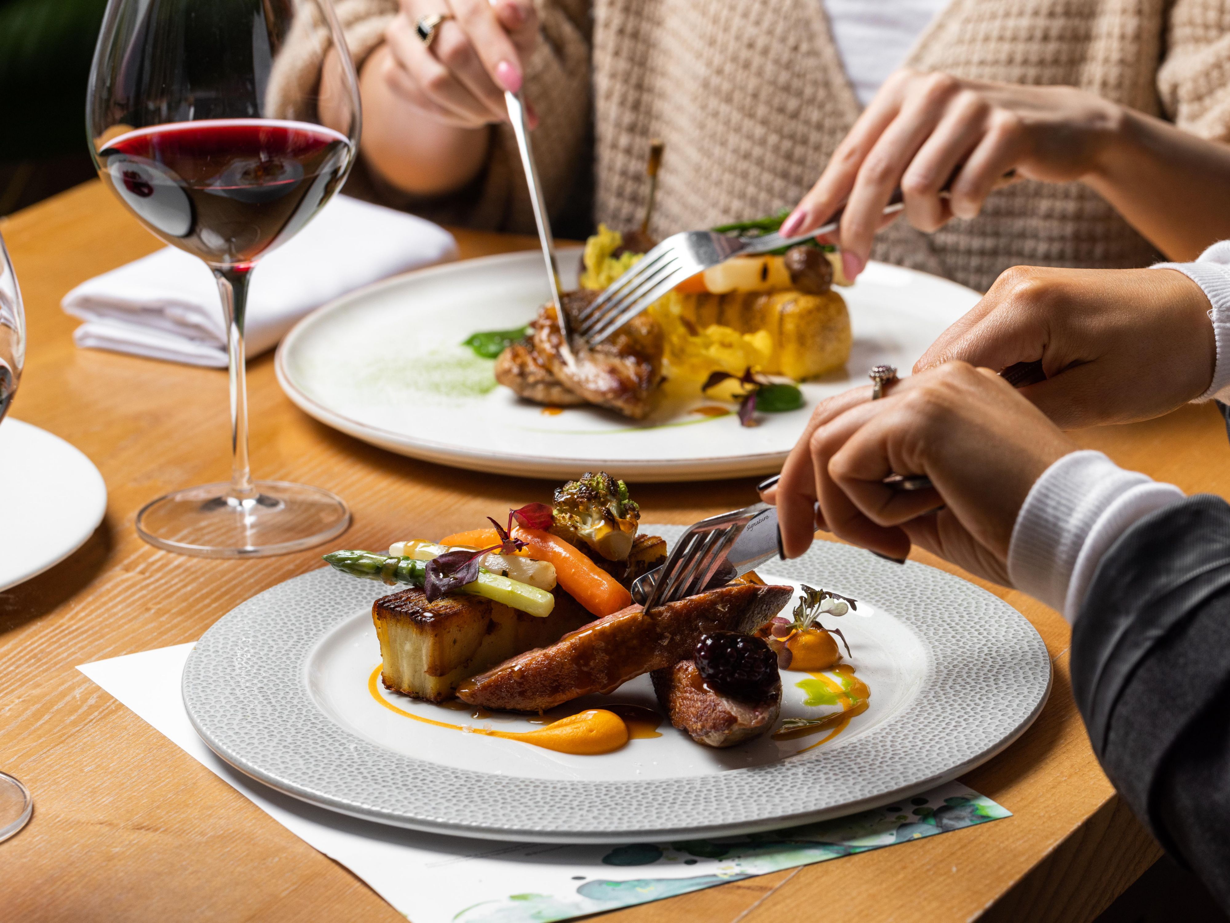 Guest cutting into dinner