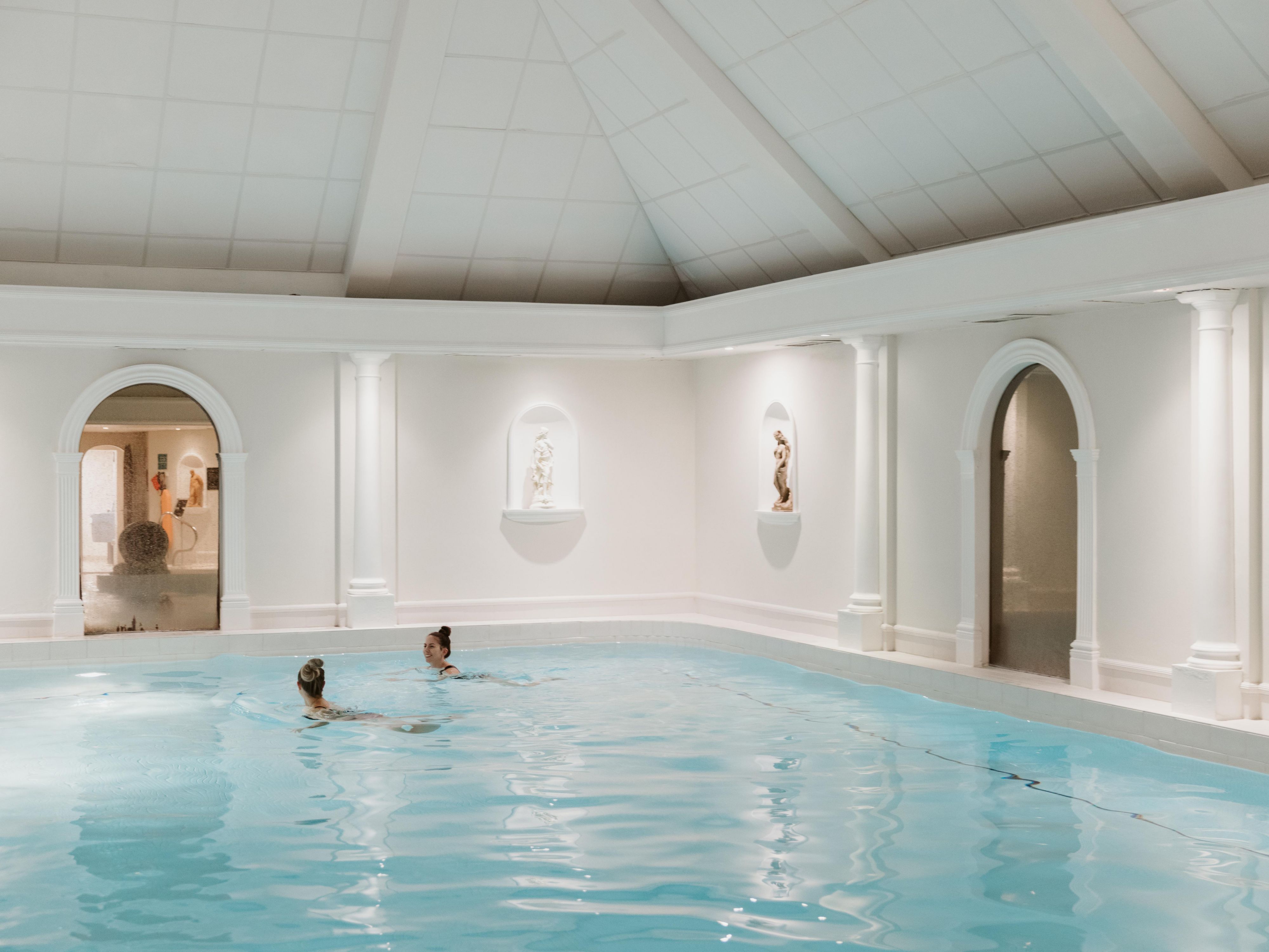 Hotel pool with a mural in the background