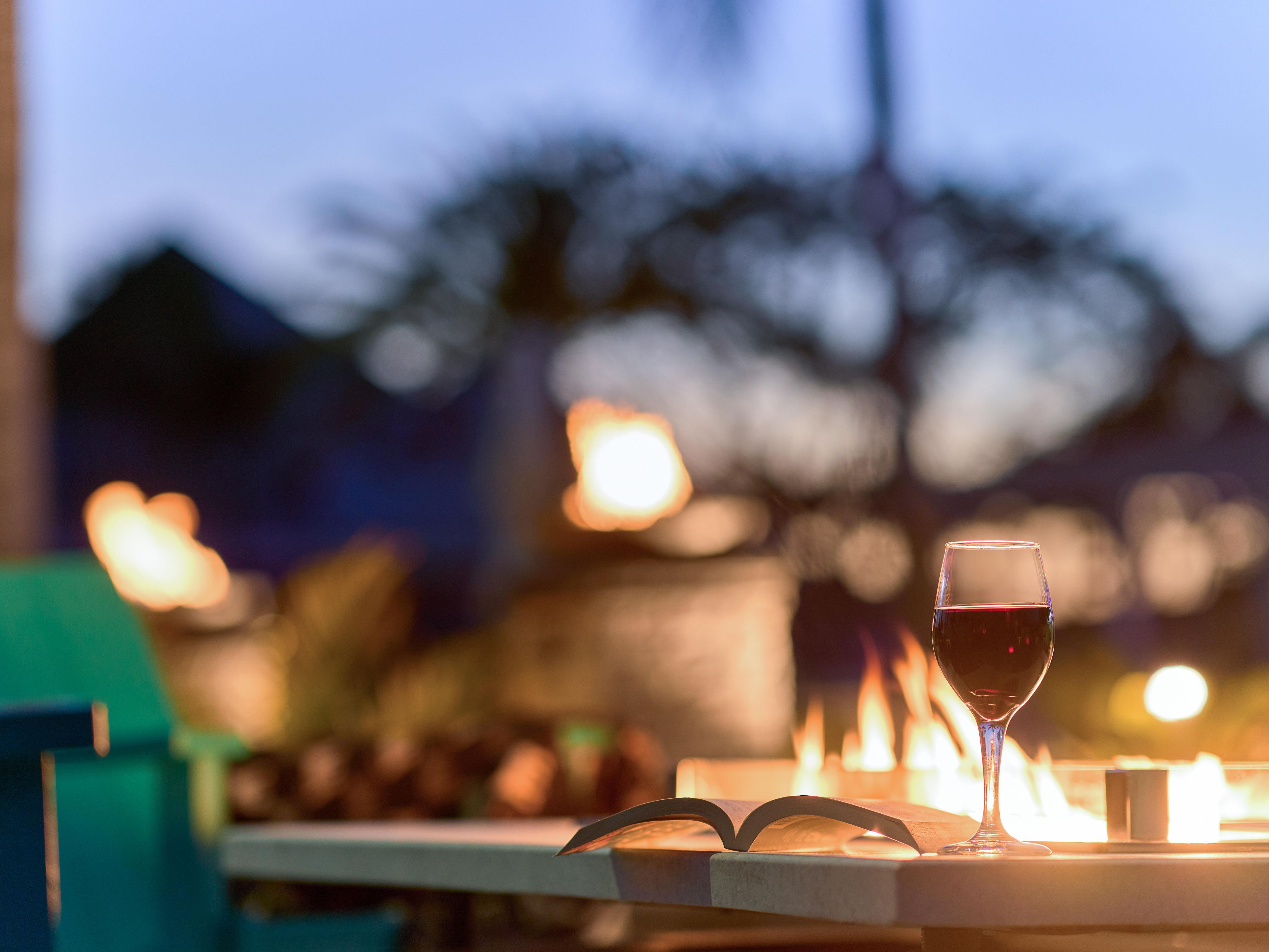 Enjoying a glass of wine by the firepits