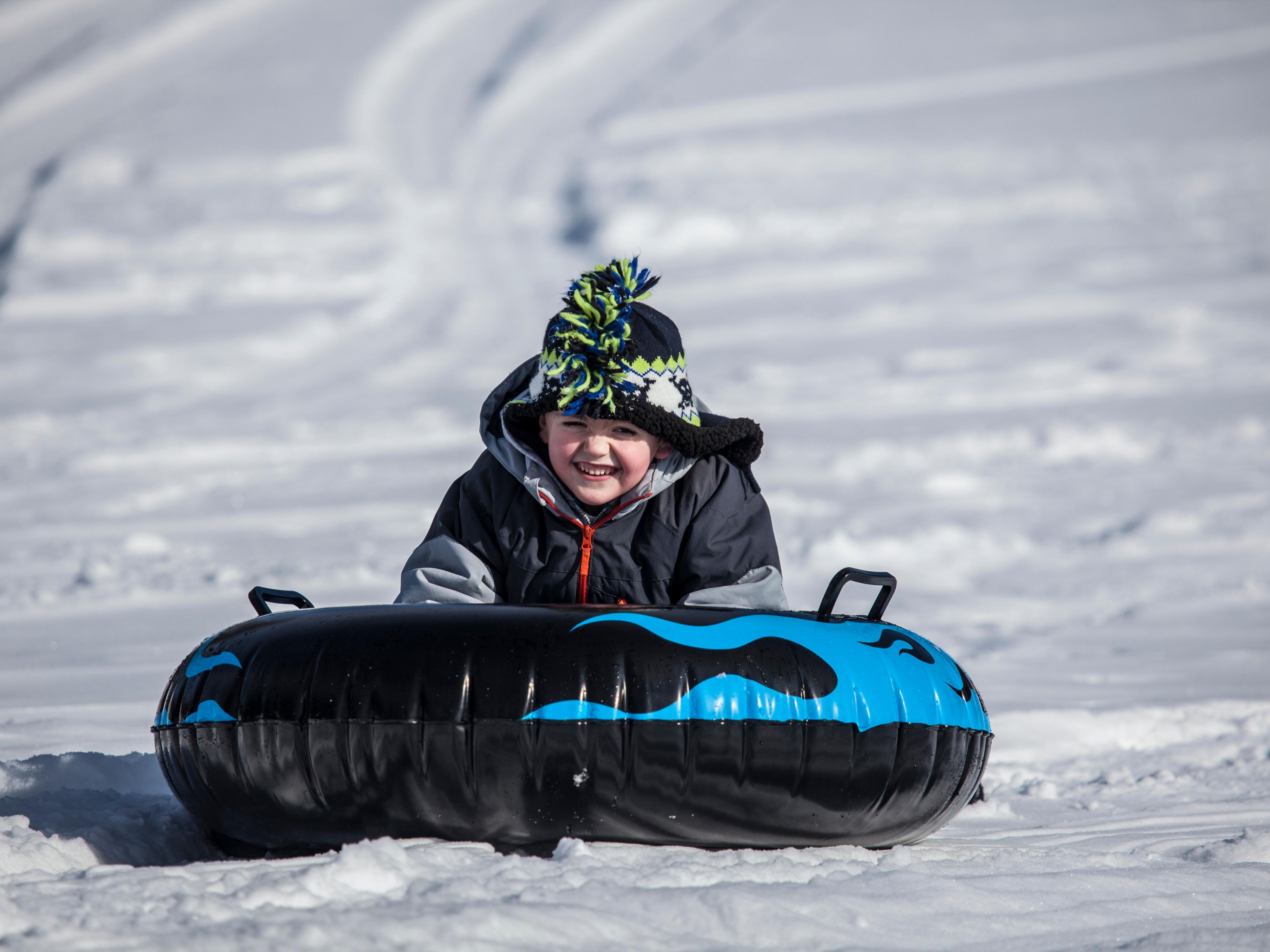 Kids tubing down a mountain