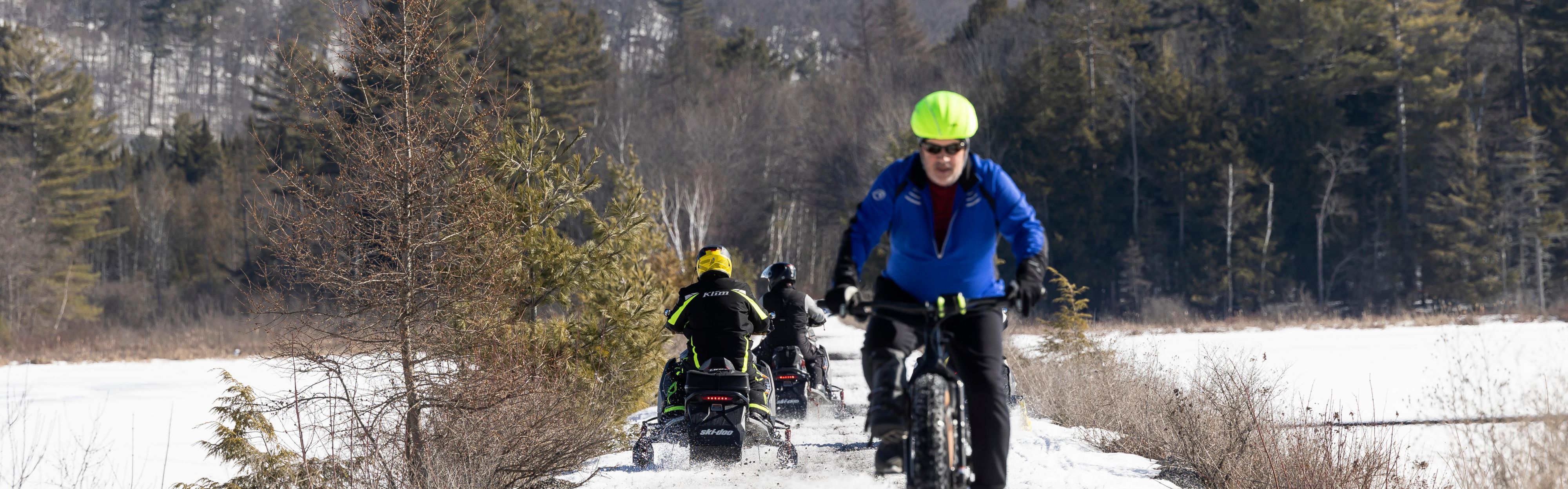 Man riding a bike through the snow