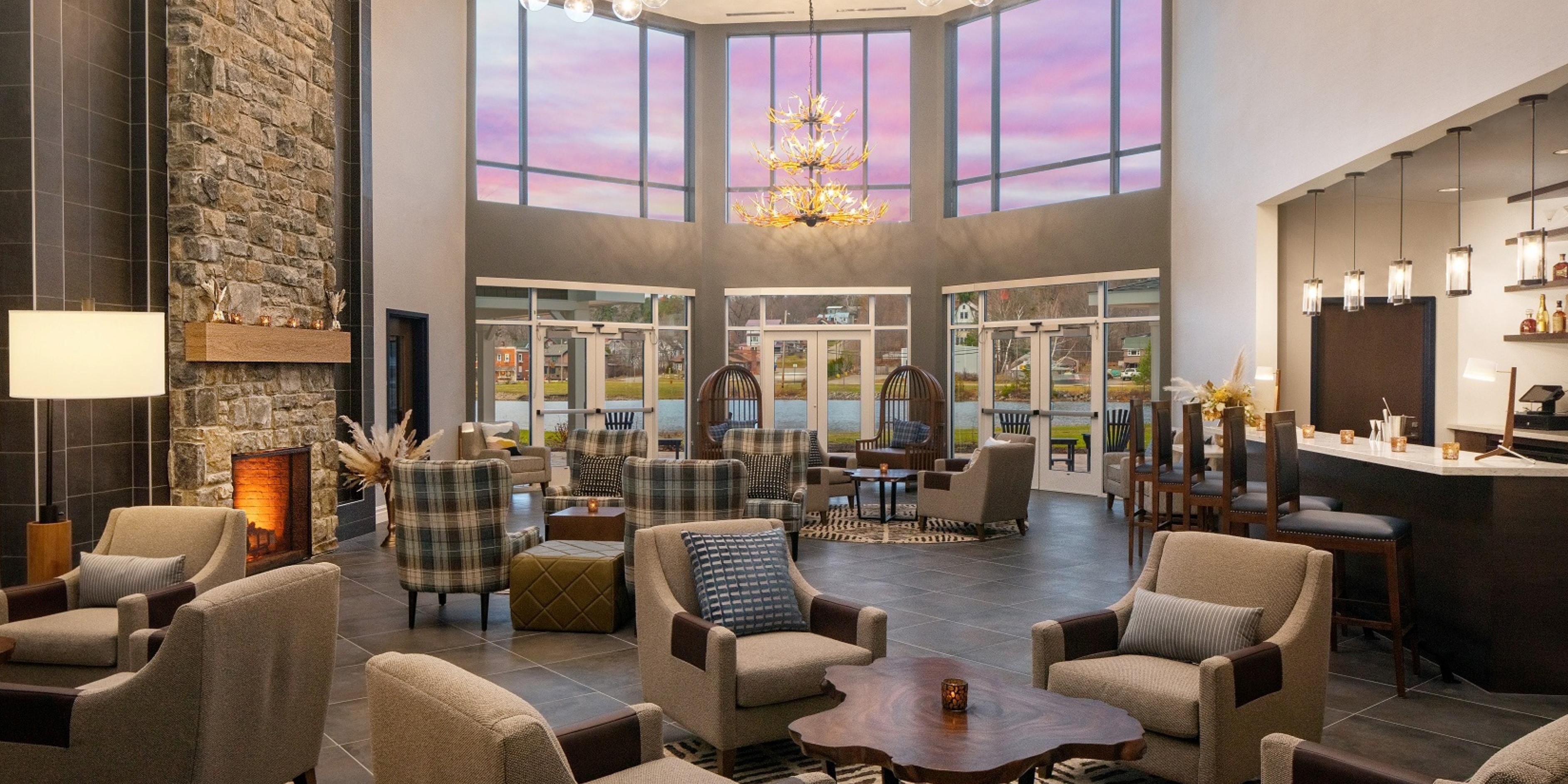 Relax in the solarium’s sunlit comfort, a serene spot to unwind after exploring the Adirondacks. This bright, airy space at voco Saranac Lake NY - Waterfront invites guests to soak in natural light and Lake Flower water views year-round.