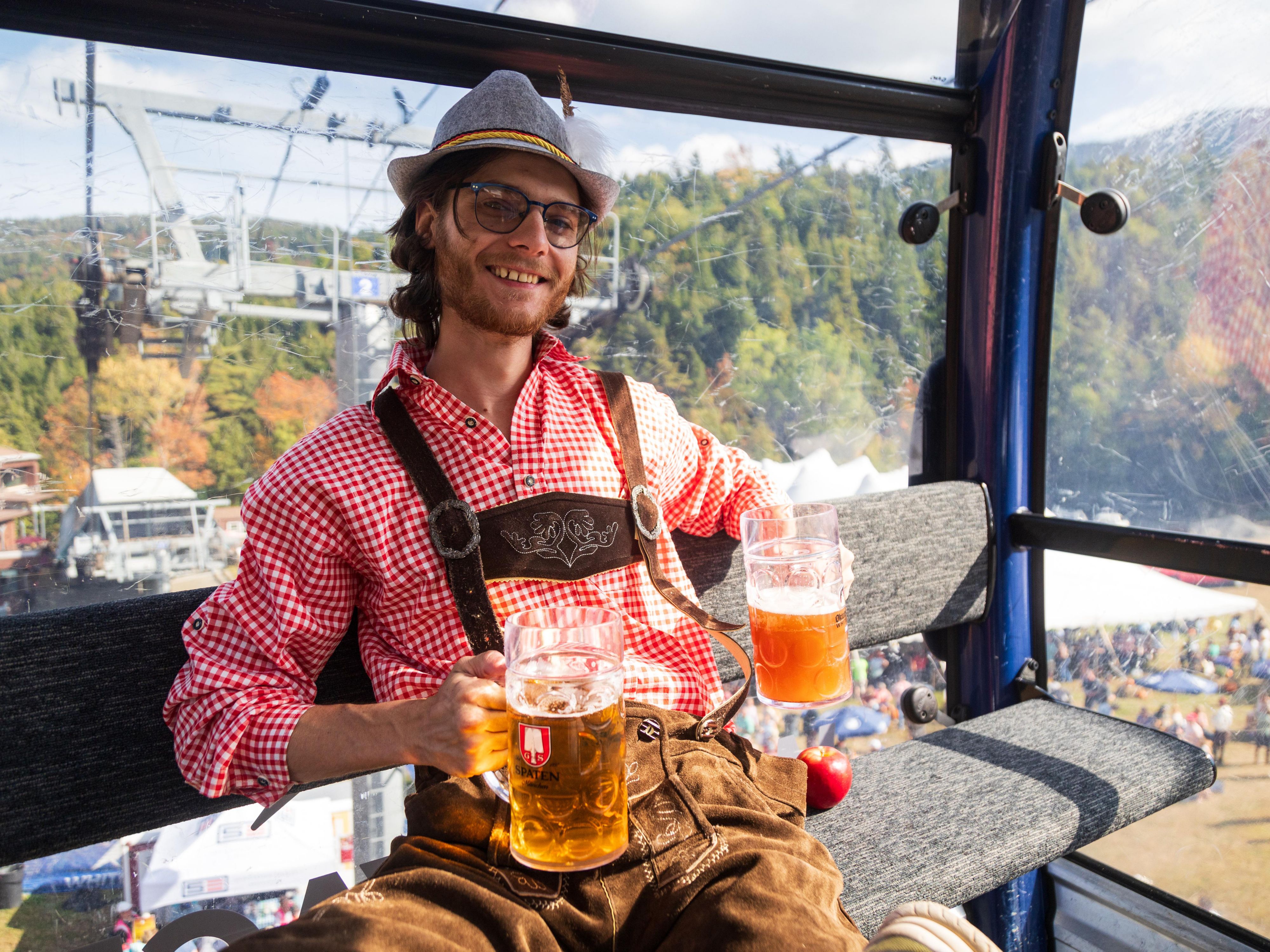 Man on ski lift with a beer at Octoberfest