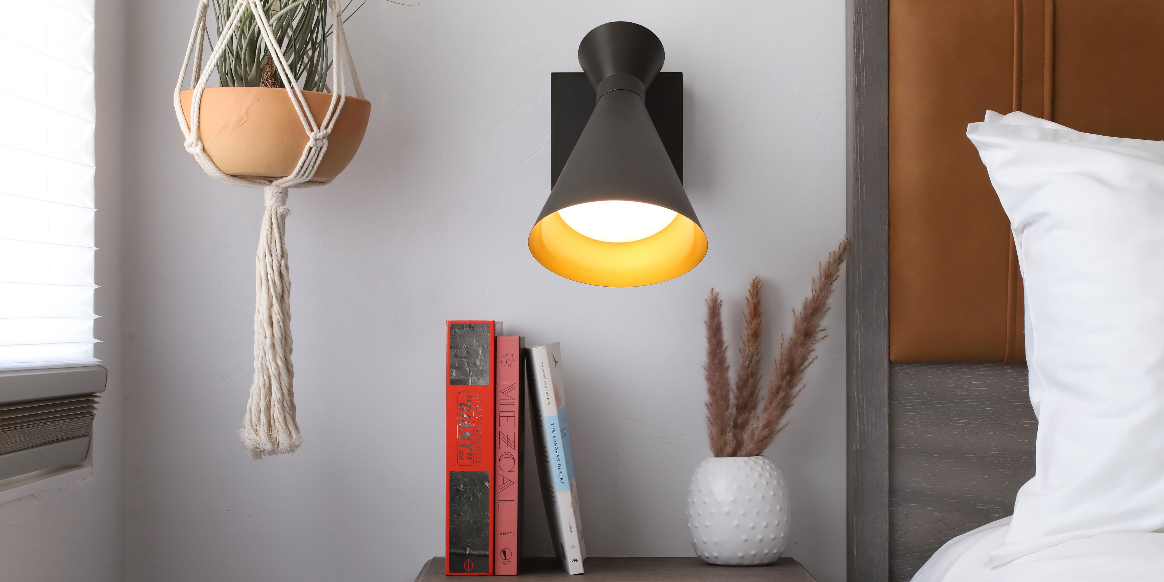 Lamp and plant by nightstand