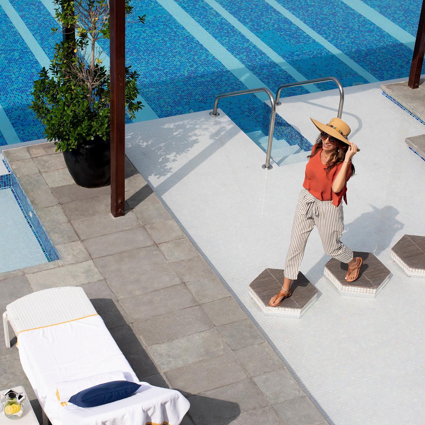 Woman walking around the pool