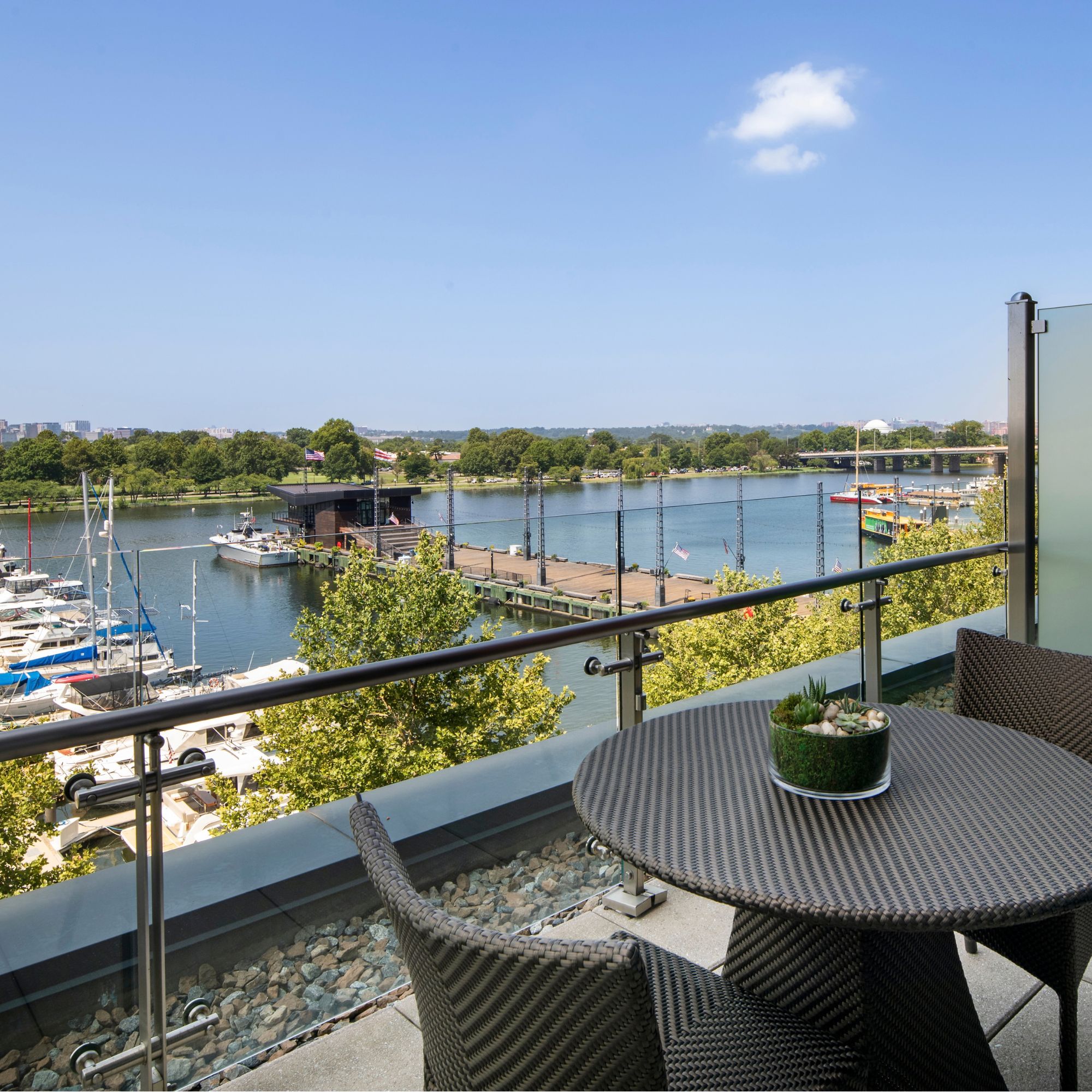 Private balcony with outdoor seating overlooking the Washington Channel, marina, and waterfront views at InterContinental Washington D.C. - The Wharf.