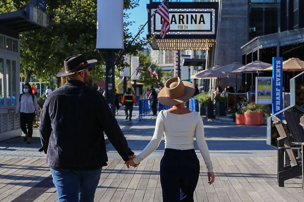 Couple walking down the street at The Wharf.