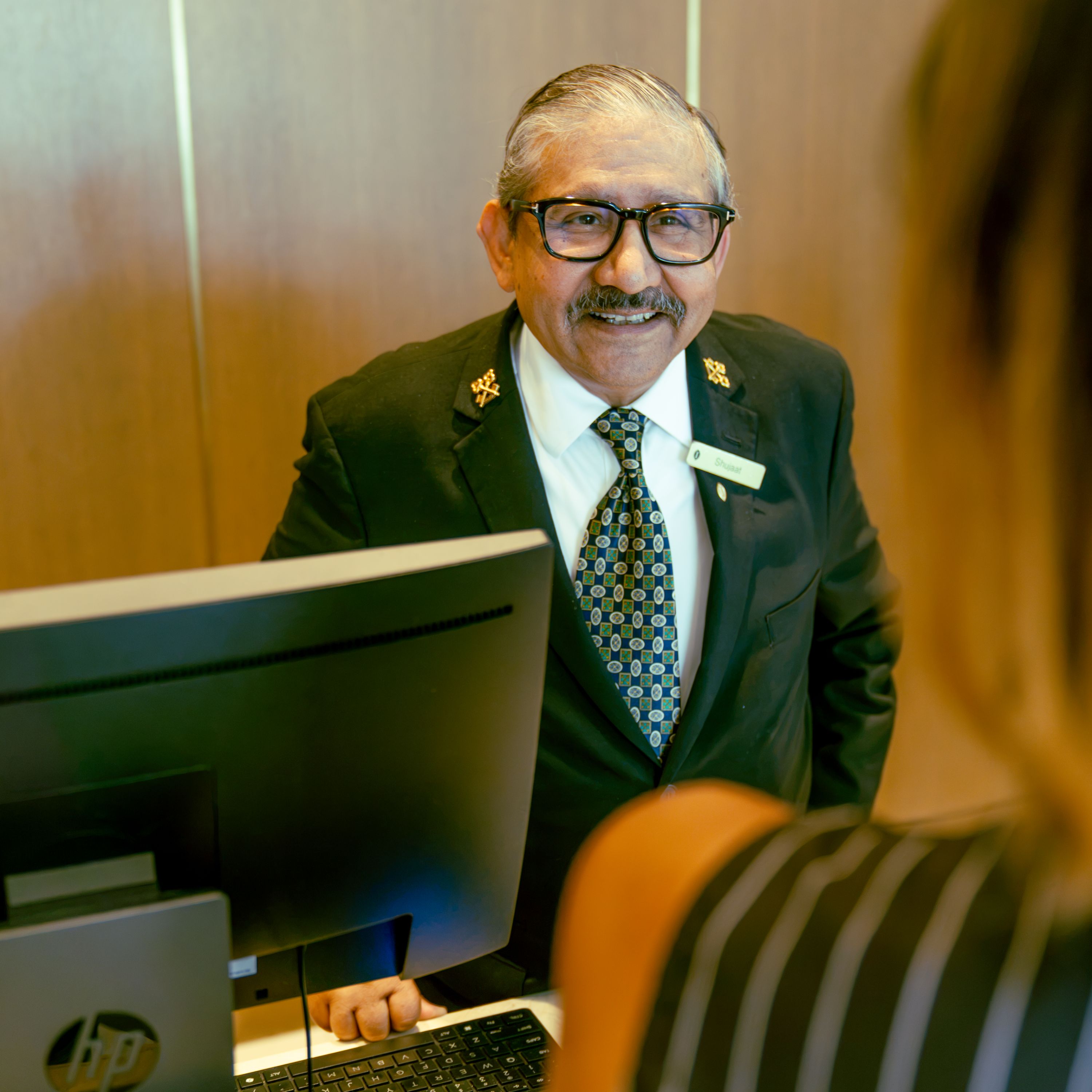 Concierge welcoming a guest at the front desk in D.C.