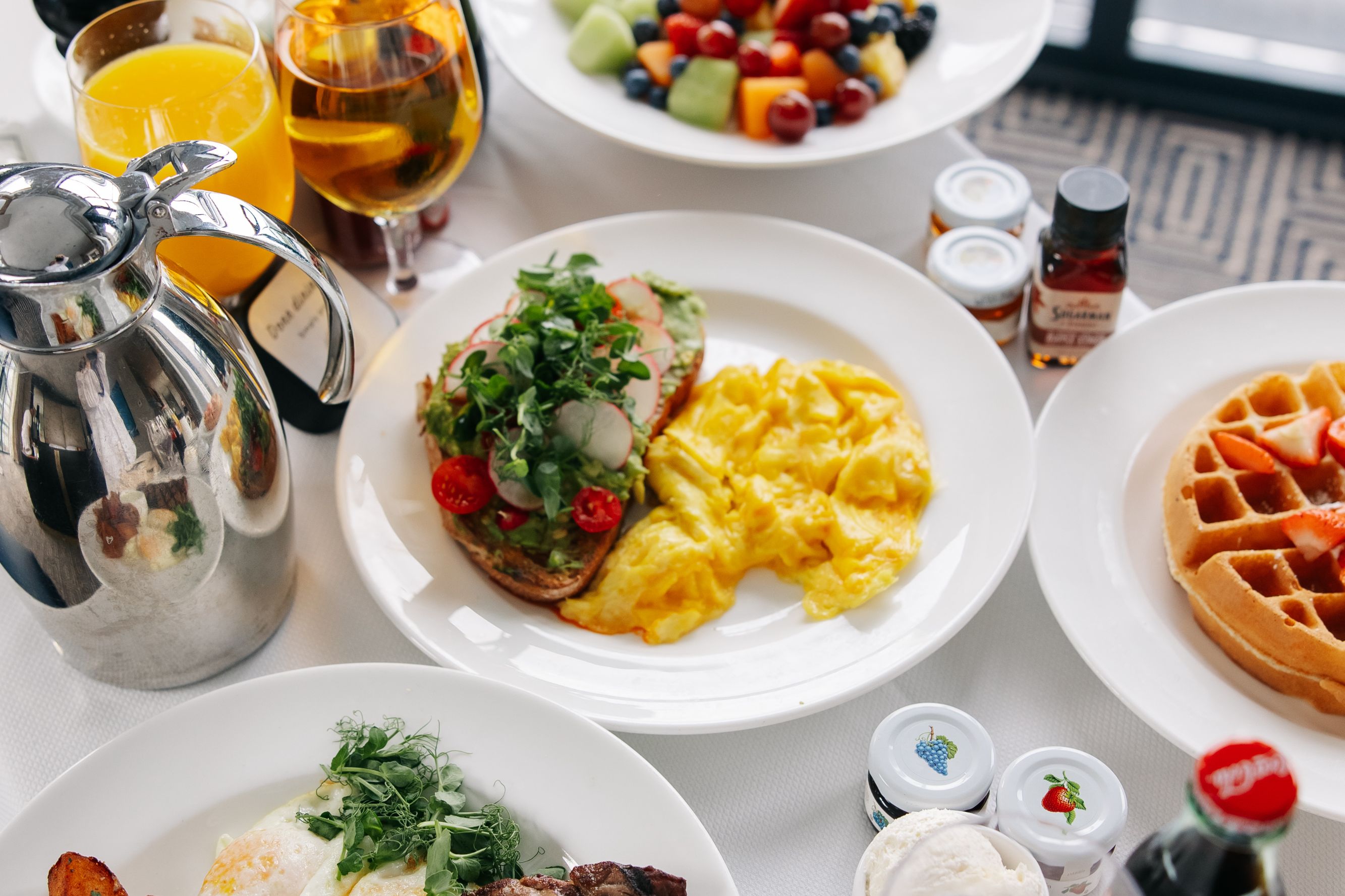 In-Room Dining spread with eggs, toast, waffles, and sides.