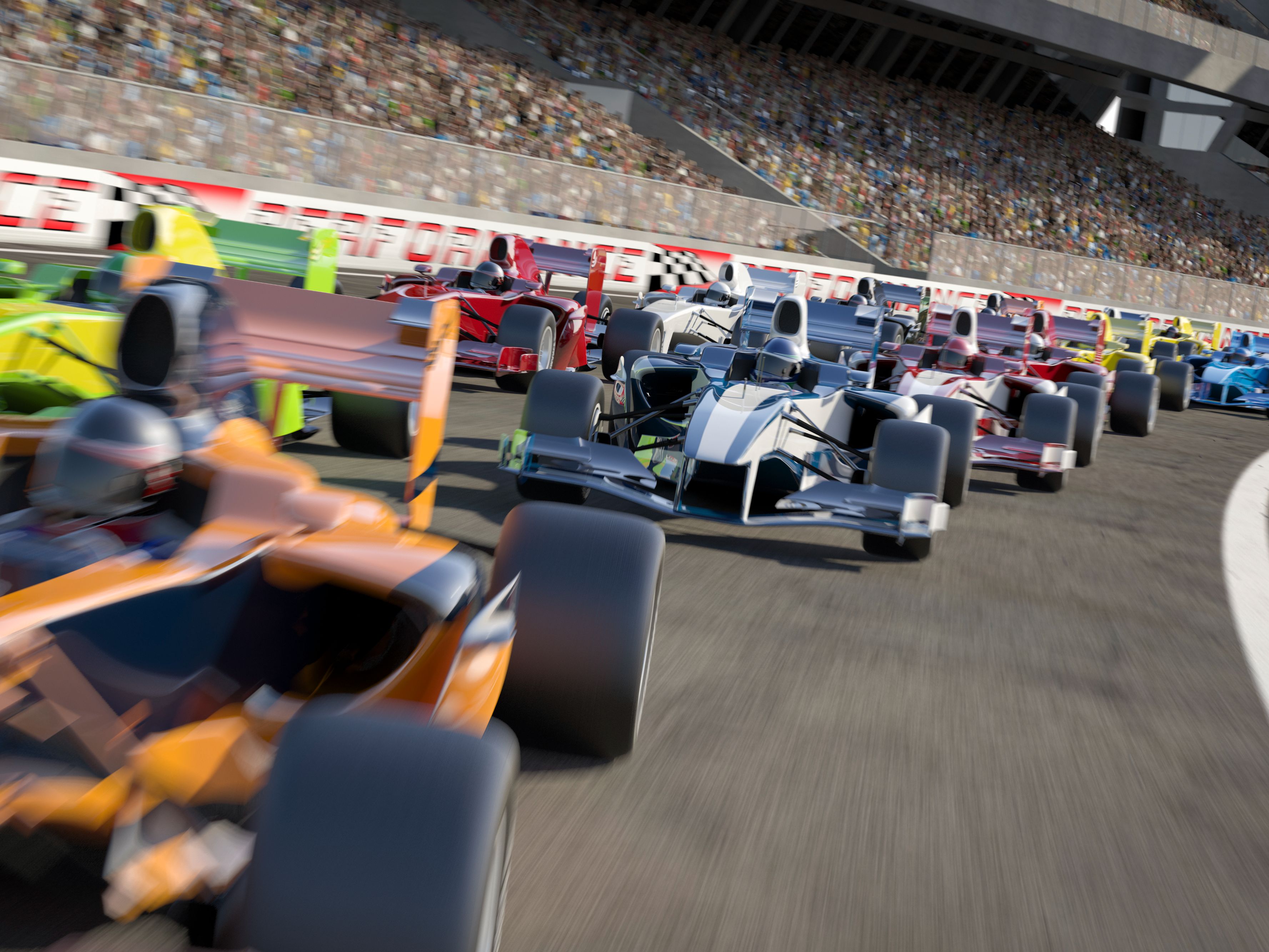Racecars speeding down a track.
