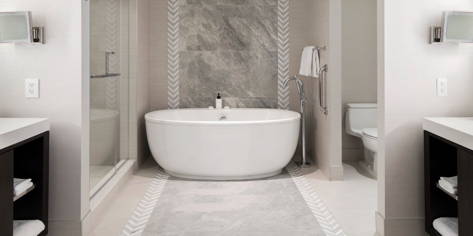 Stand-alone soaking tub in luxurious suite bathroom.