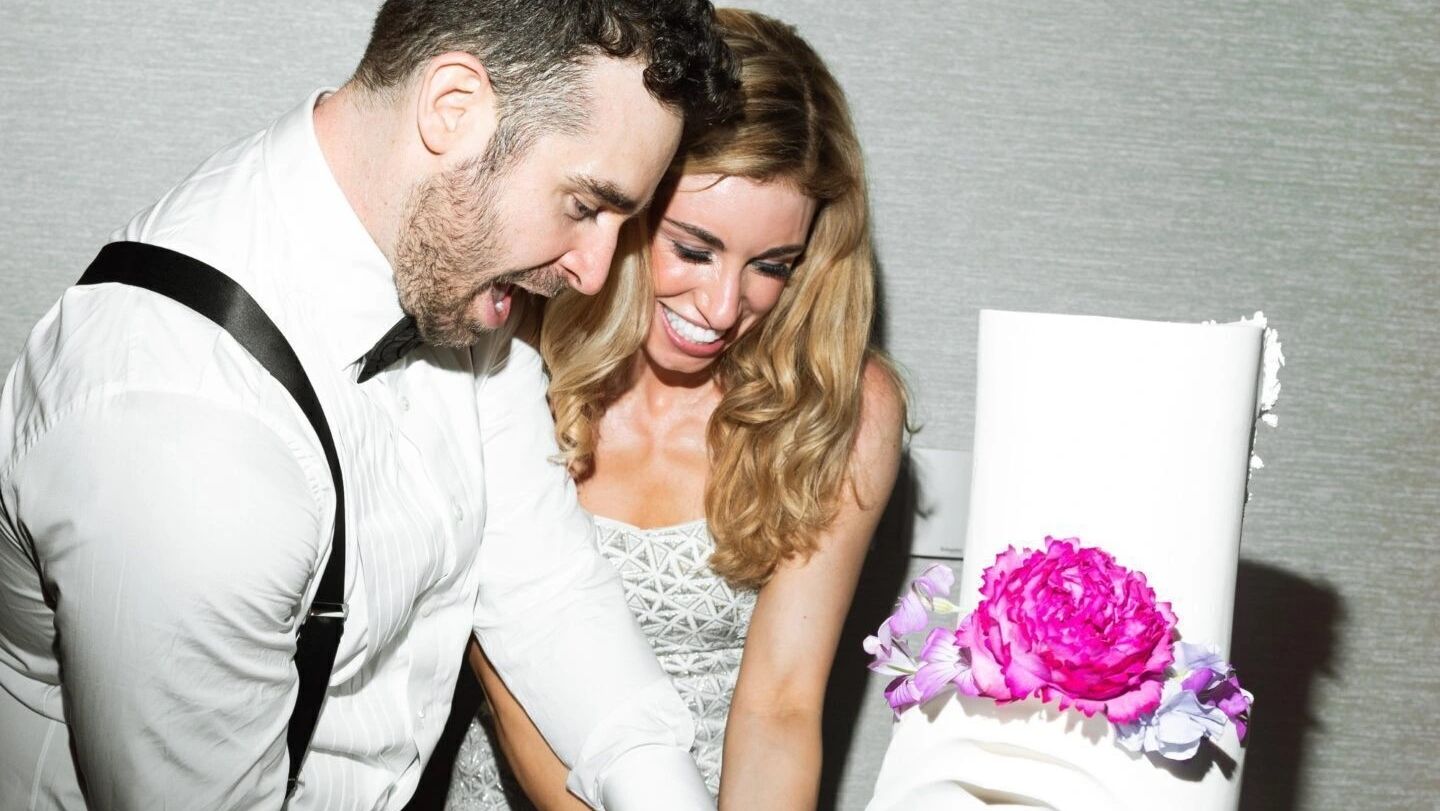 bride and groom cutting cake