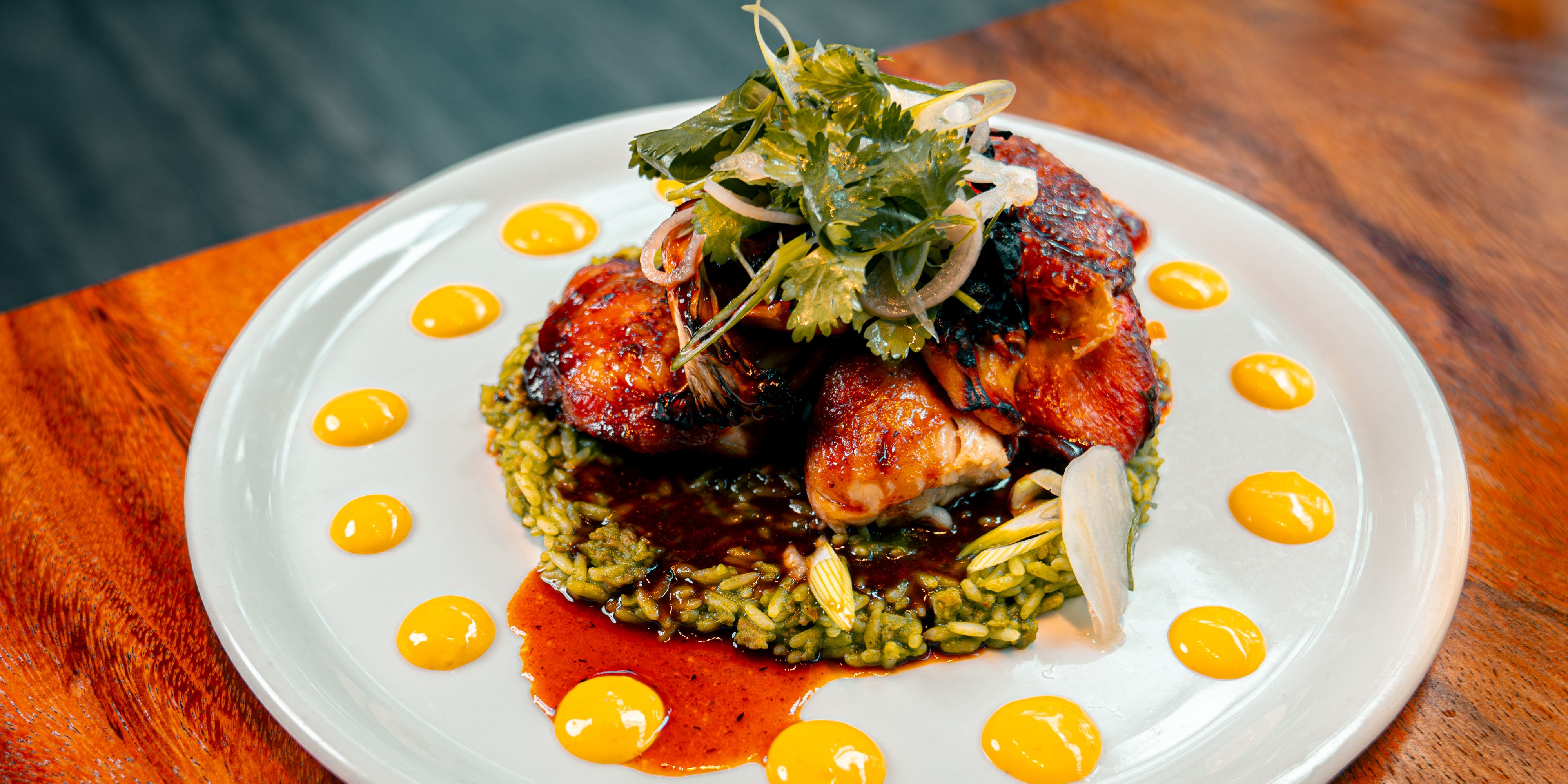 Smoked chicken with green rice and lemon pan jus.