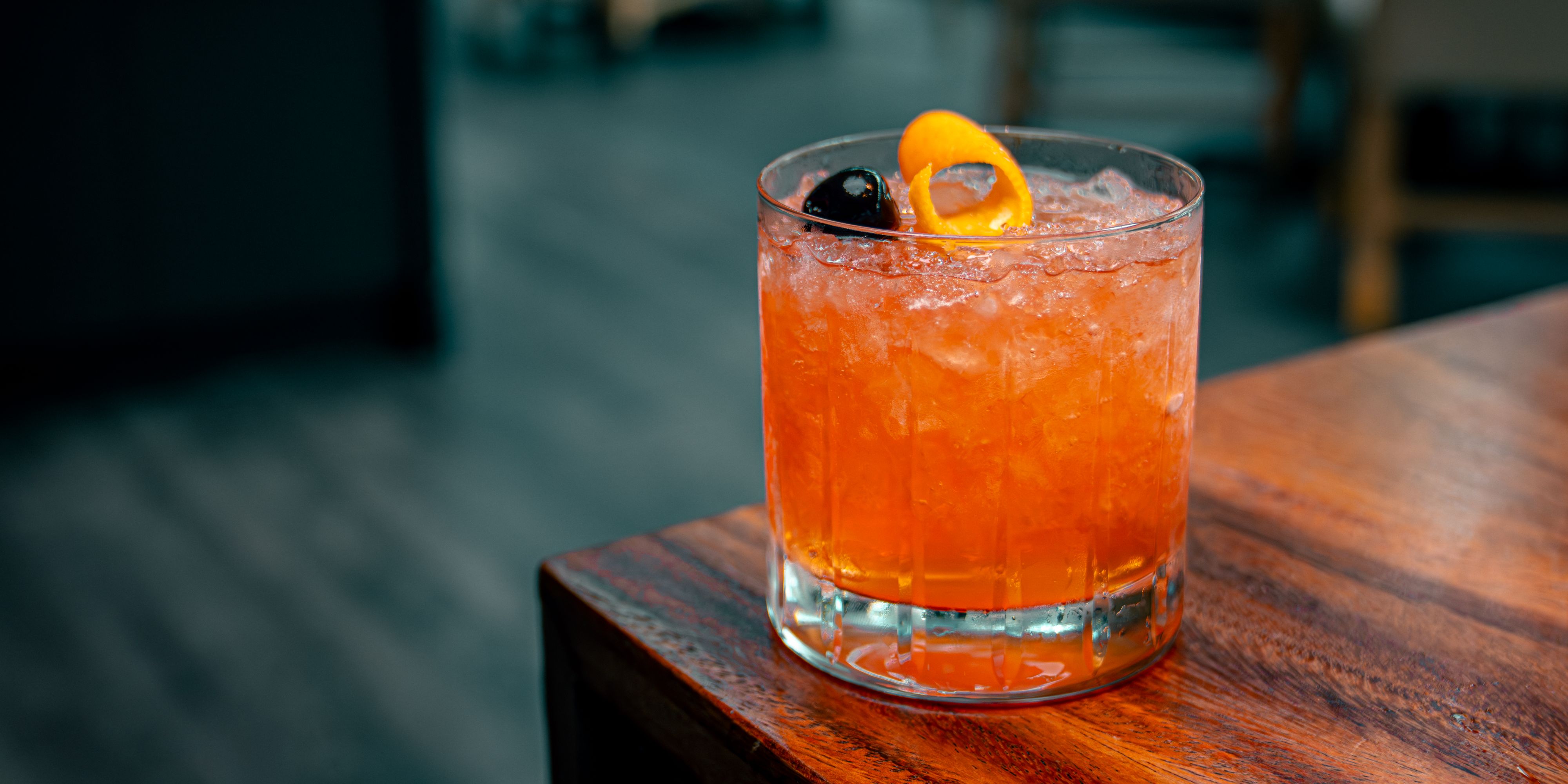 Old fashioned with citrus peel and cherry.