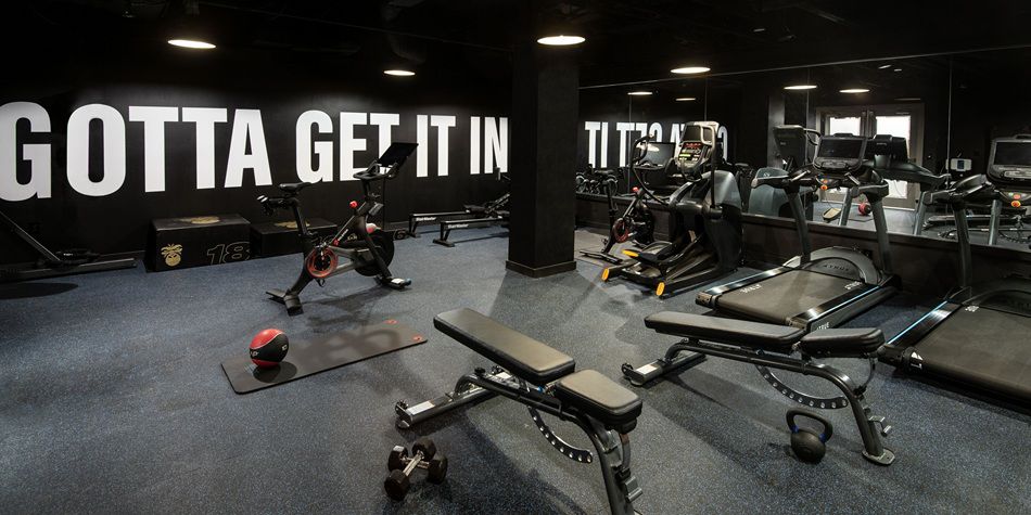 Hotel fitness center featuring ellipticals and weight benches