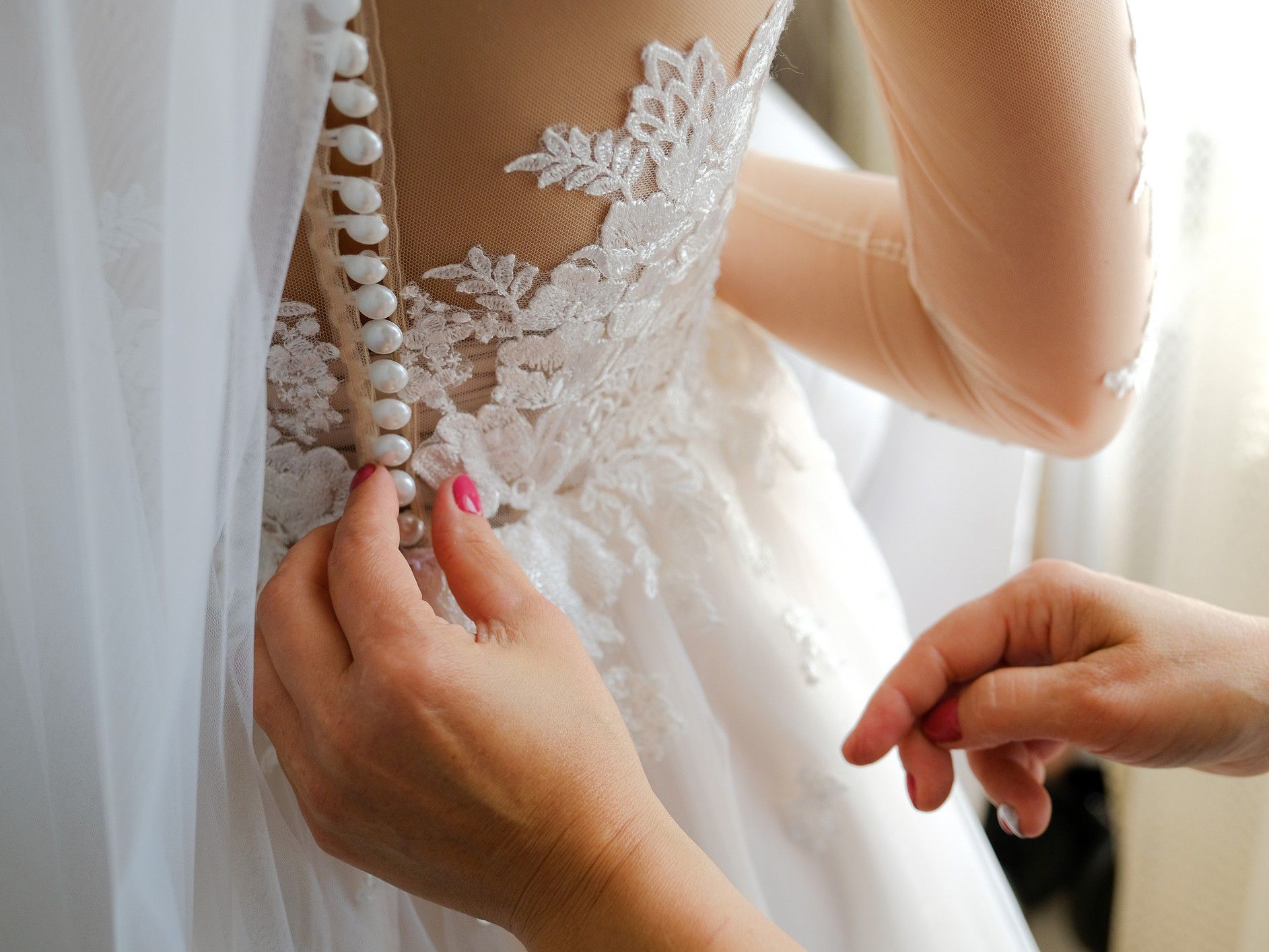 Helping do up a wedding dress