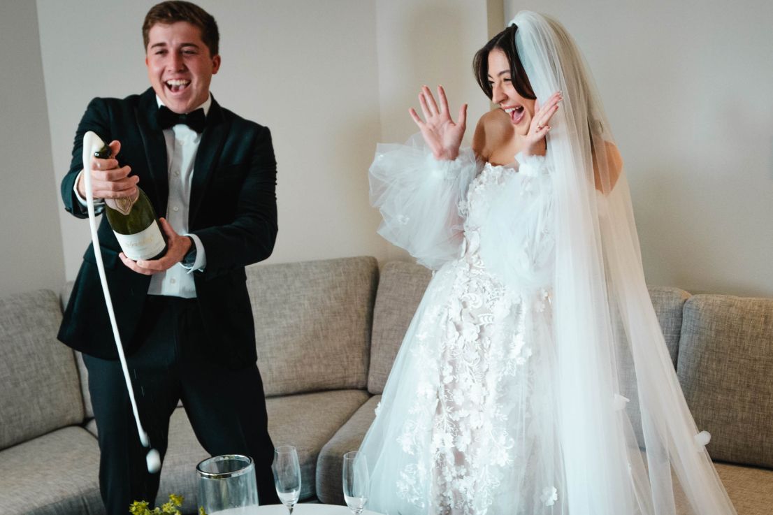 Bride and Groom sharing champagne after wedding