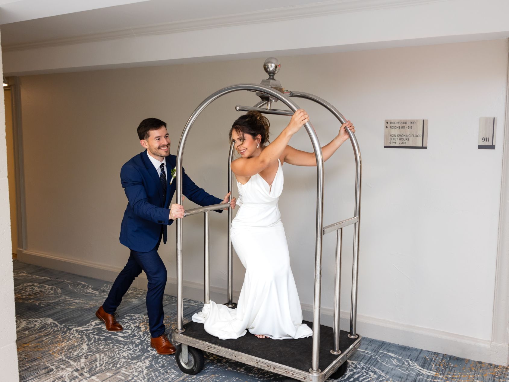 Bride and groom riding on hotel cart