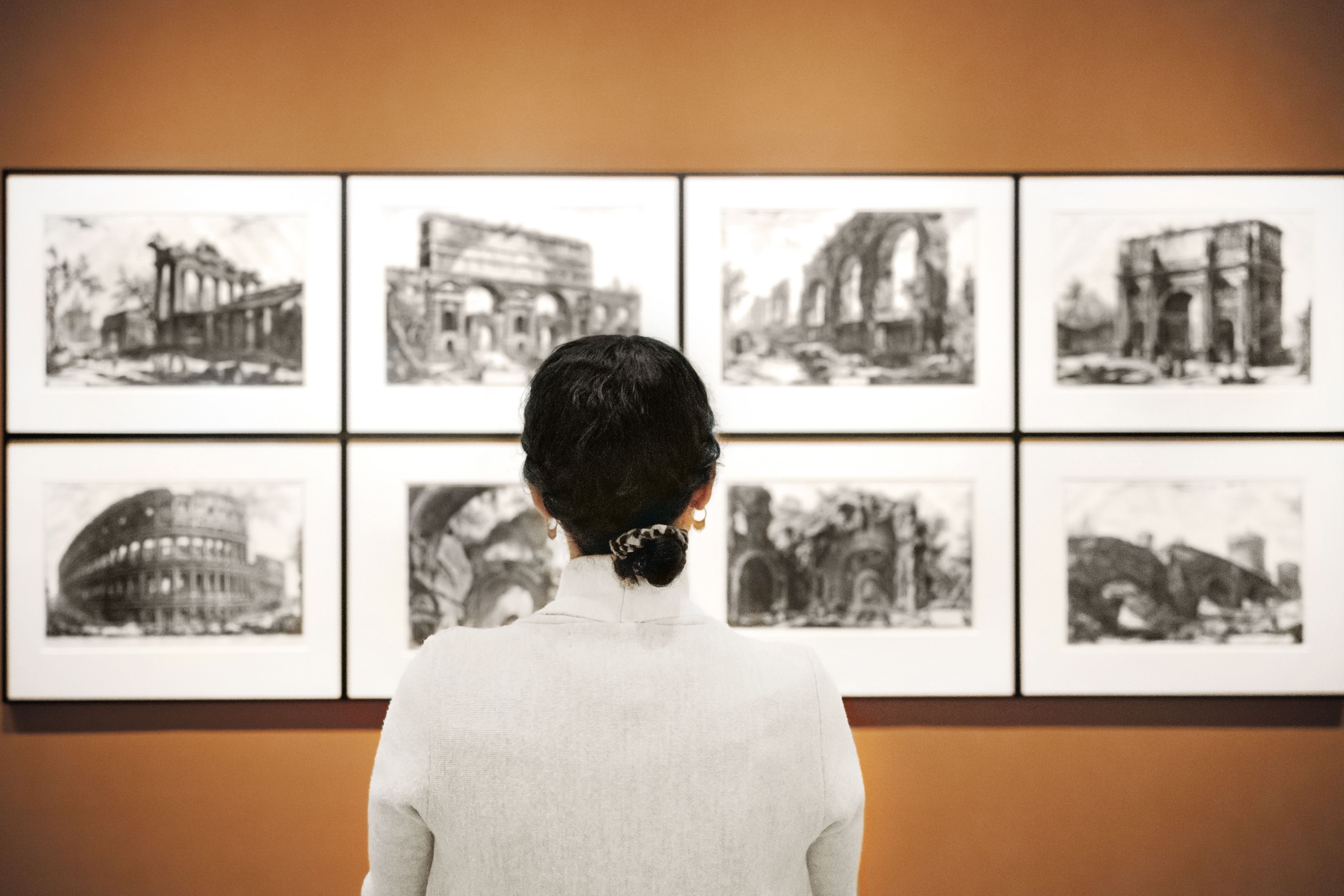 Woman standing in front of museum display.
