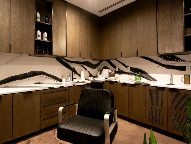 Empty black leather barber chair in Groom Guy