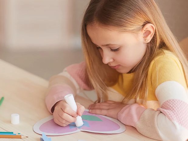 Girl coloring a heart