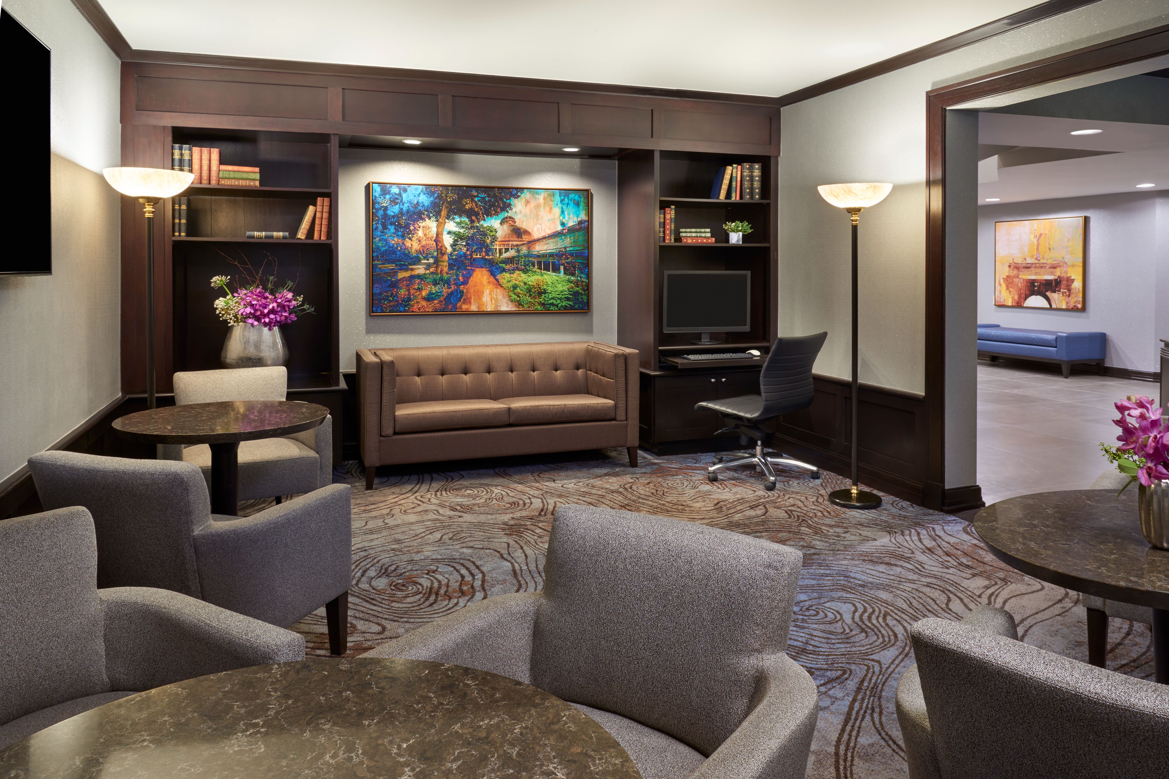 Club library area with lounge seating and tables.
