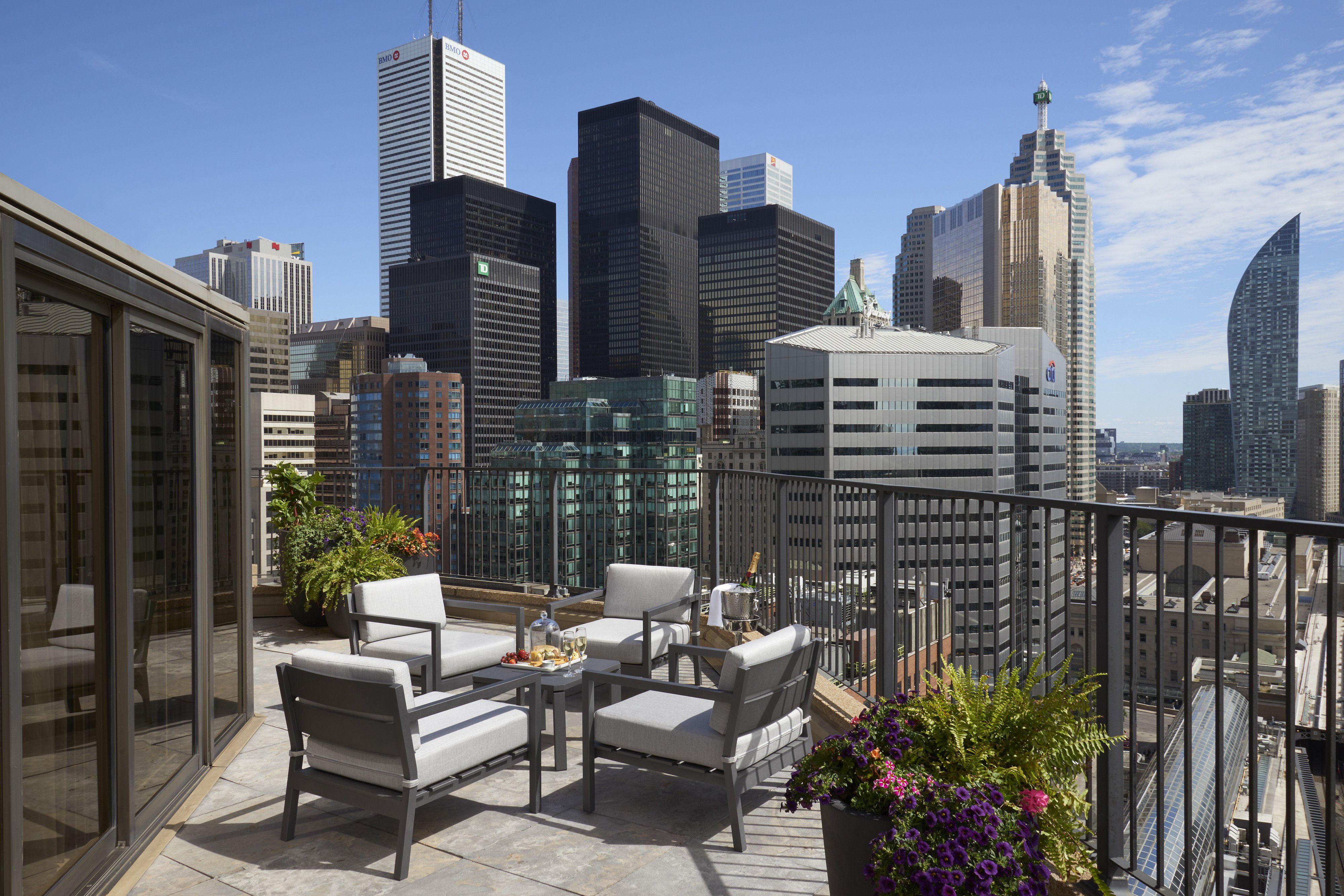 Rooftop patio with seating and skyline city views