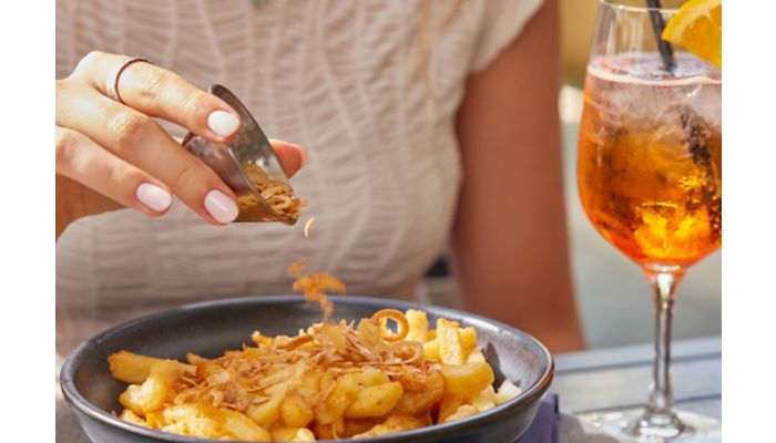 Loaded fries topped with crispy shallots and cocktail.