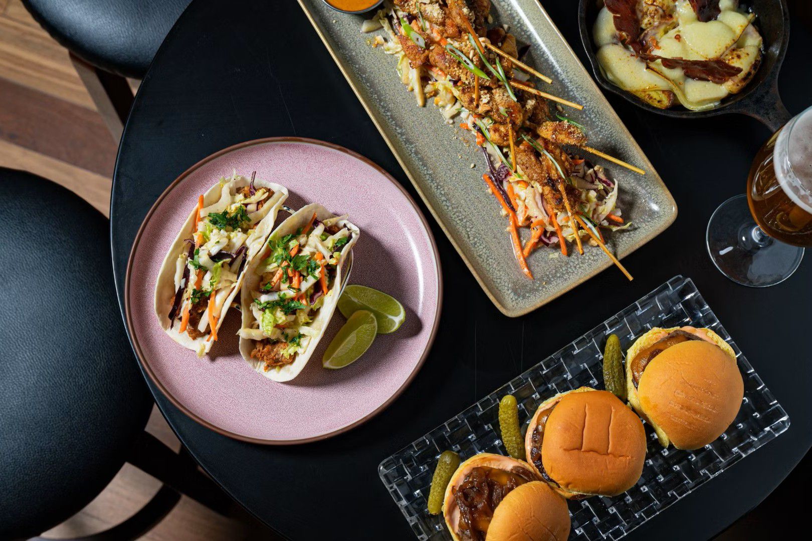 lunch spread with burgers, tacos and skewers